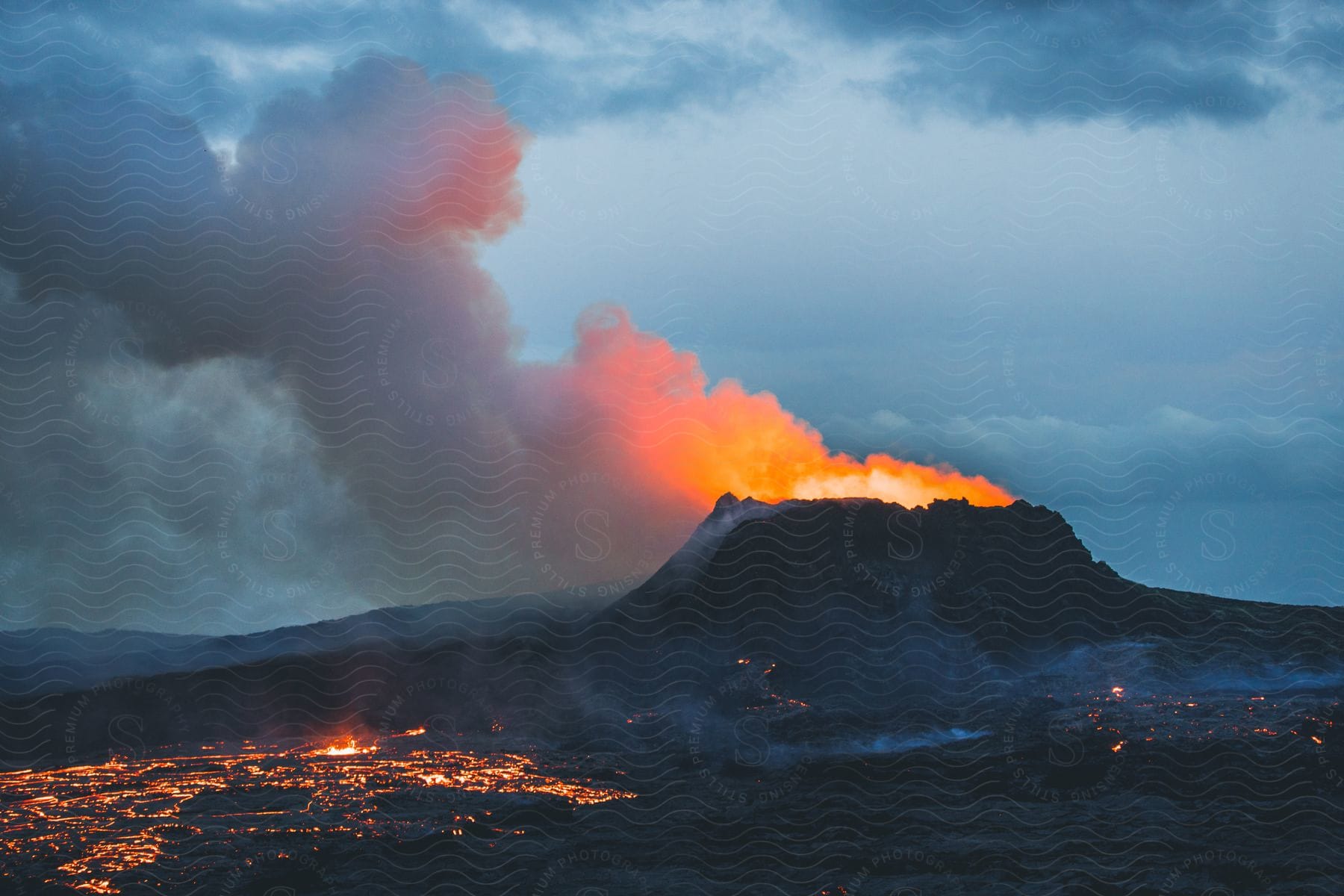 Volcano erupting spewing molten lava into the air in iceland