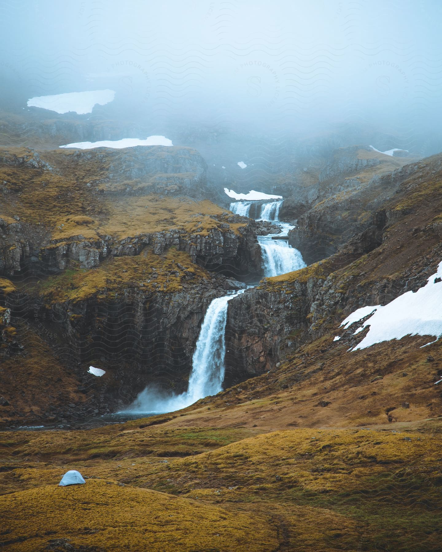 A serene landscape of a waterfall in the icelandic wilderness