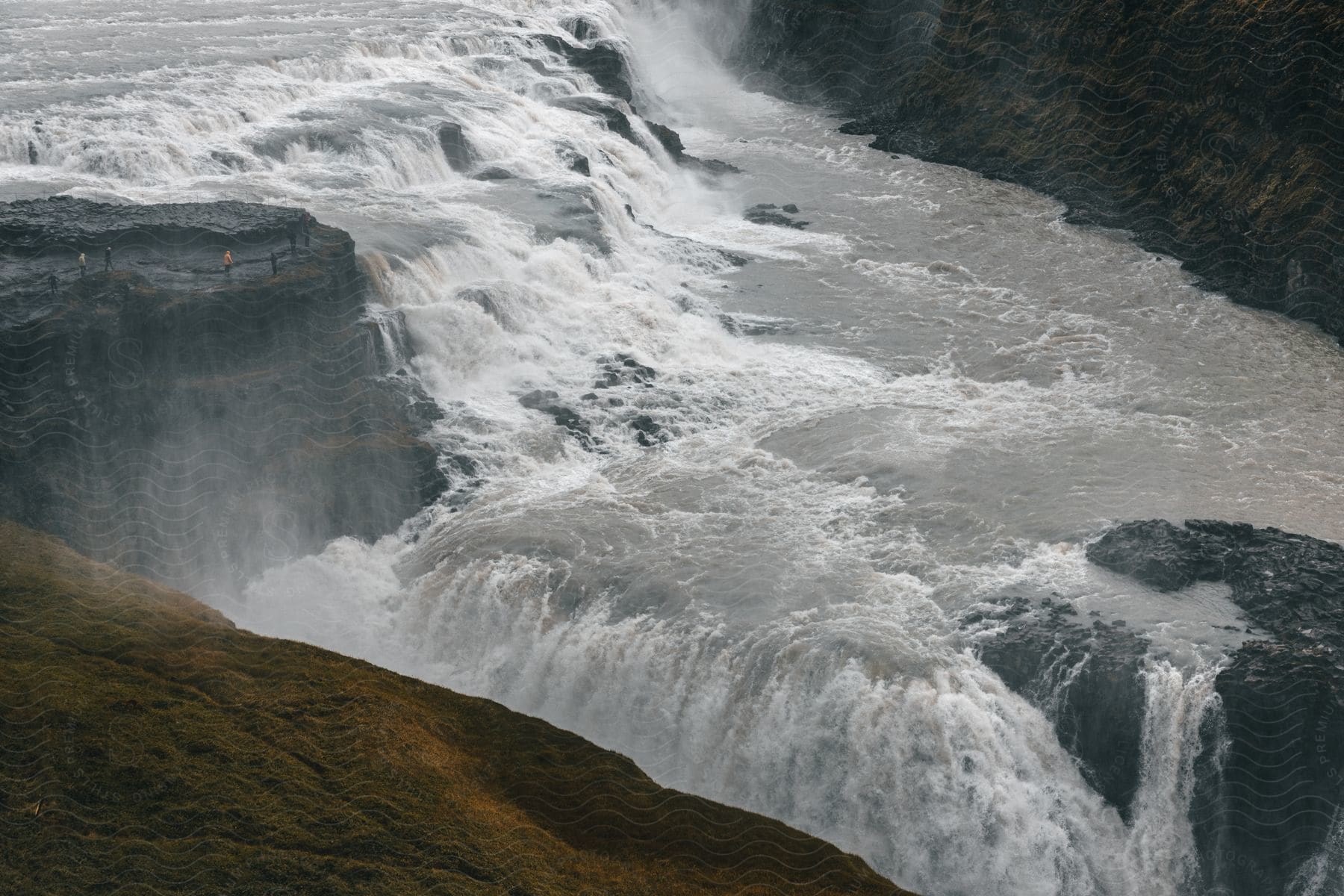 A wide waterfall surrounded by large rock formations in iceland