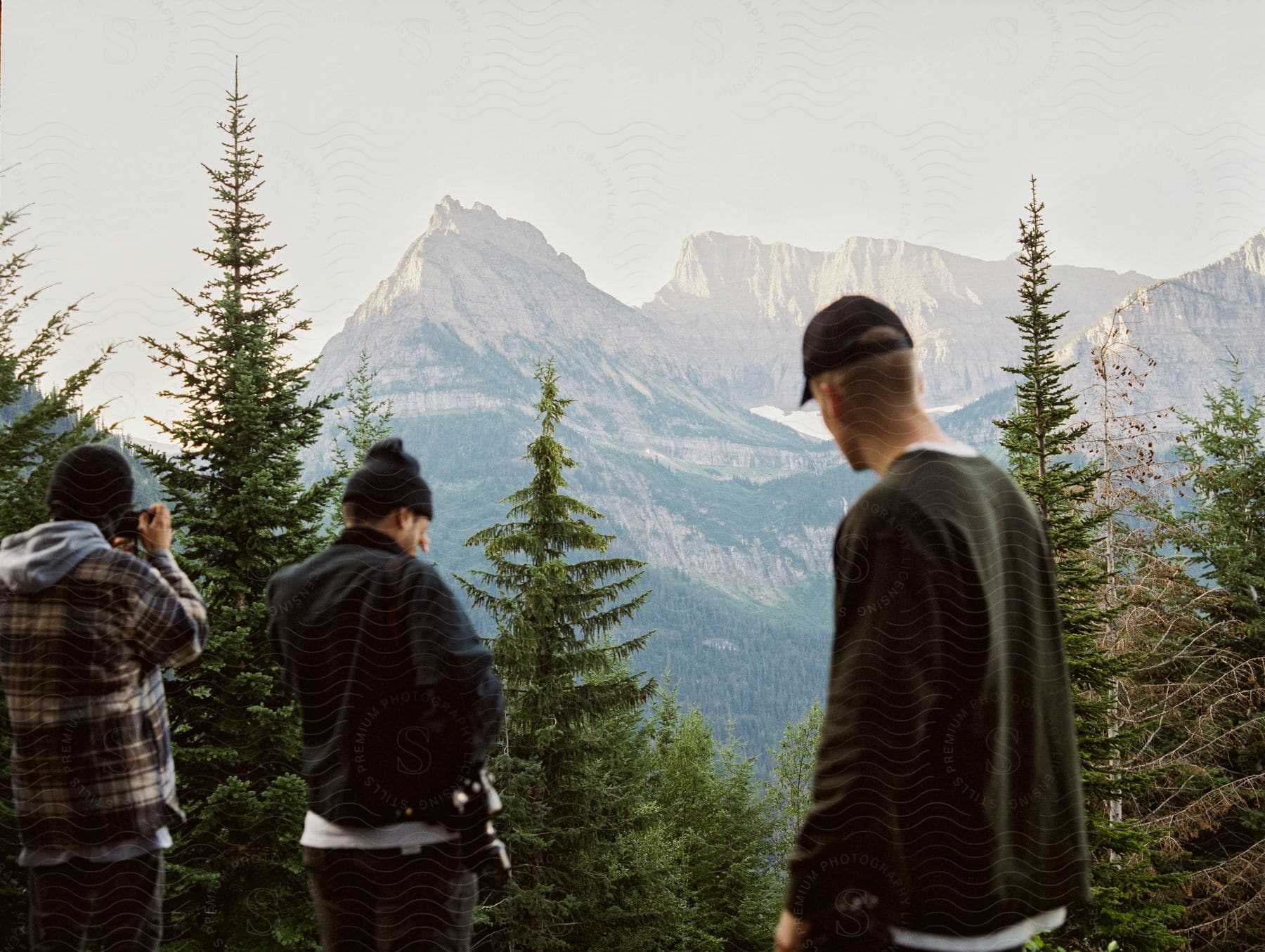 A group of photographers capturing rugged mountains in glacier national park