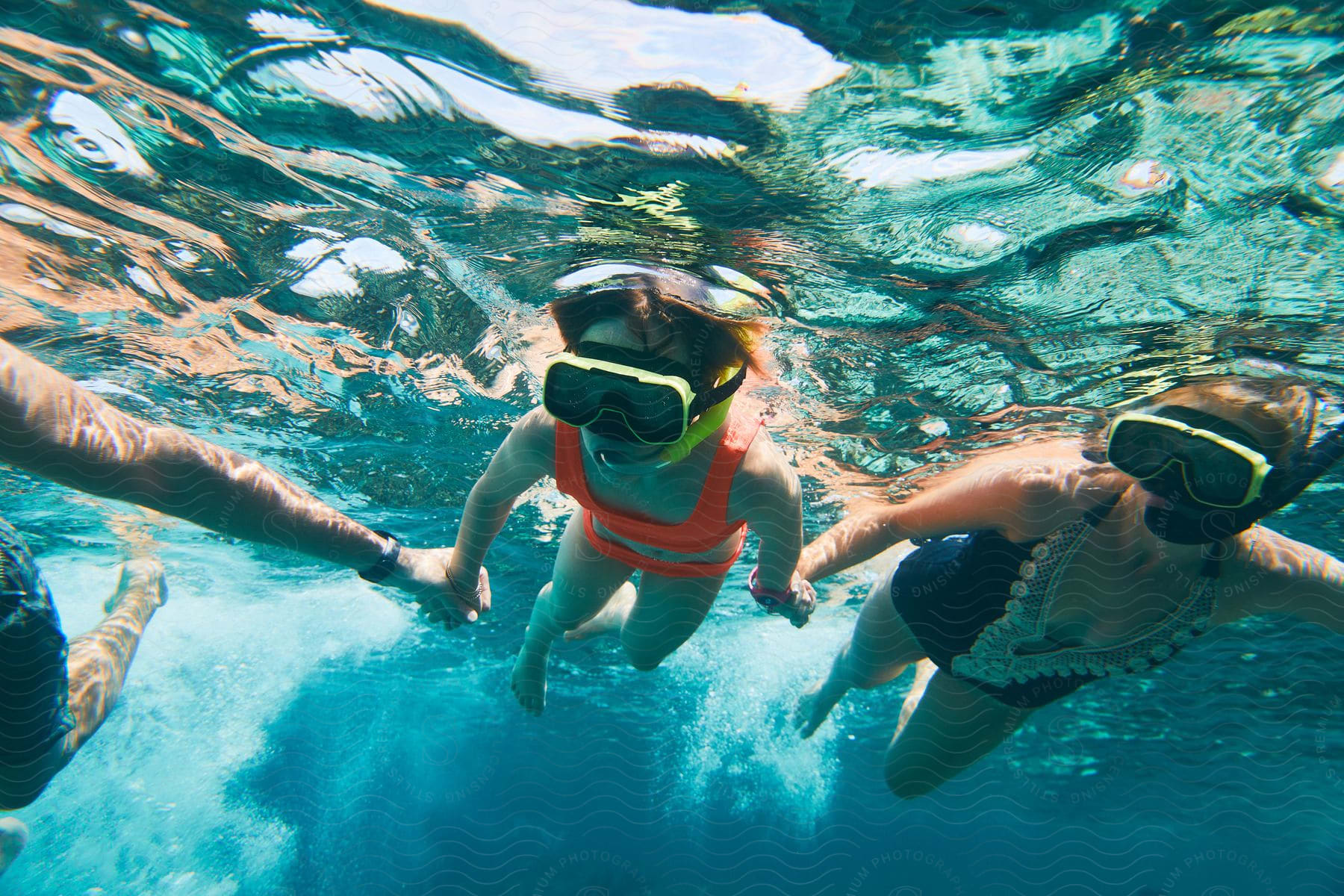 Family snorkeling together underwater in the ocean