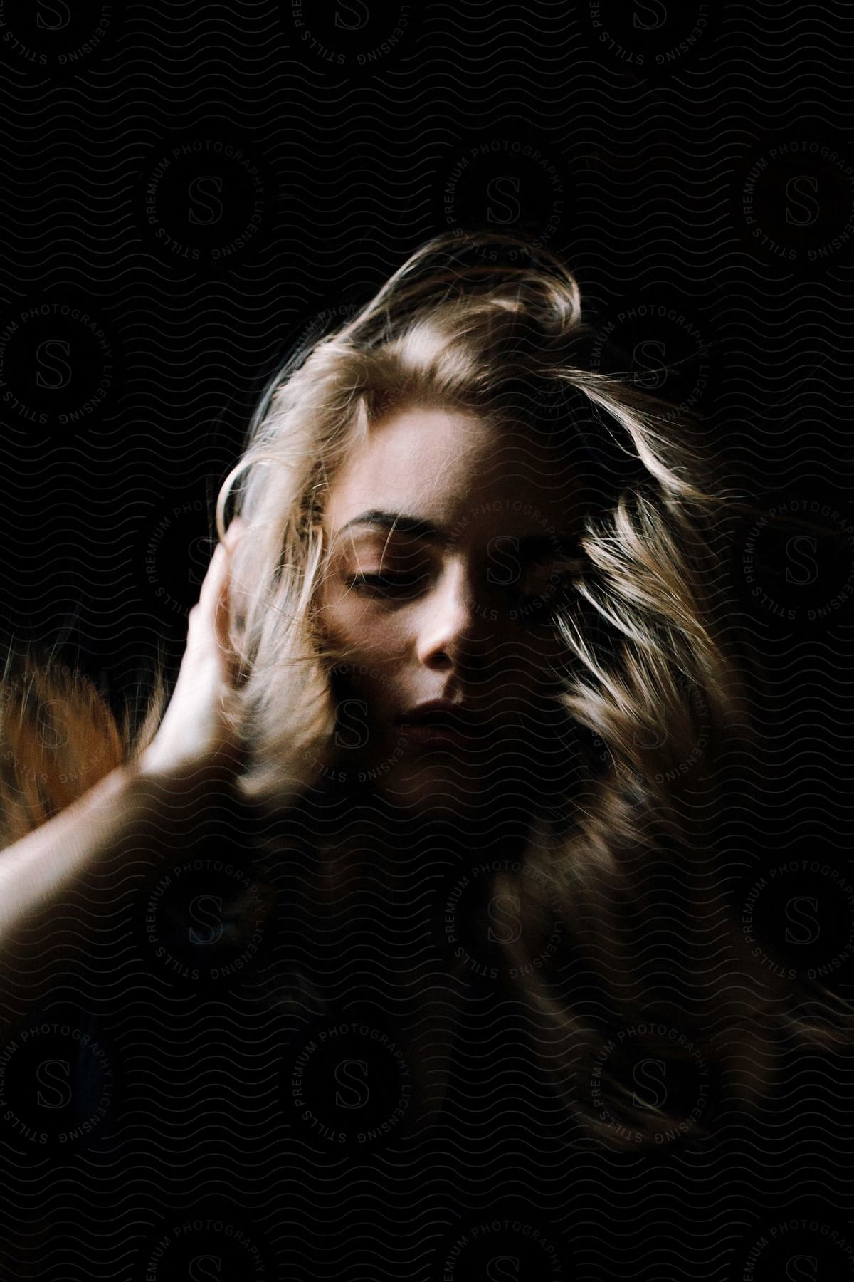 A woman posing for the camera ruffling her hair