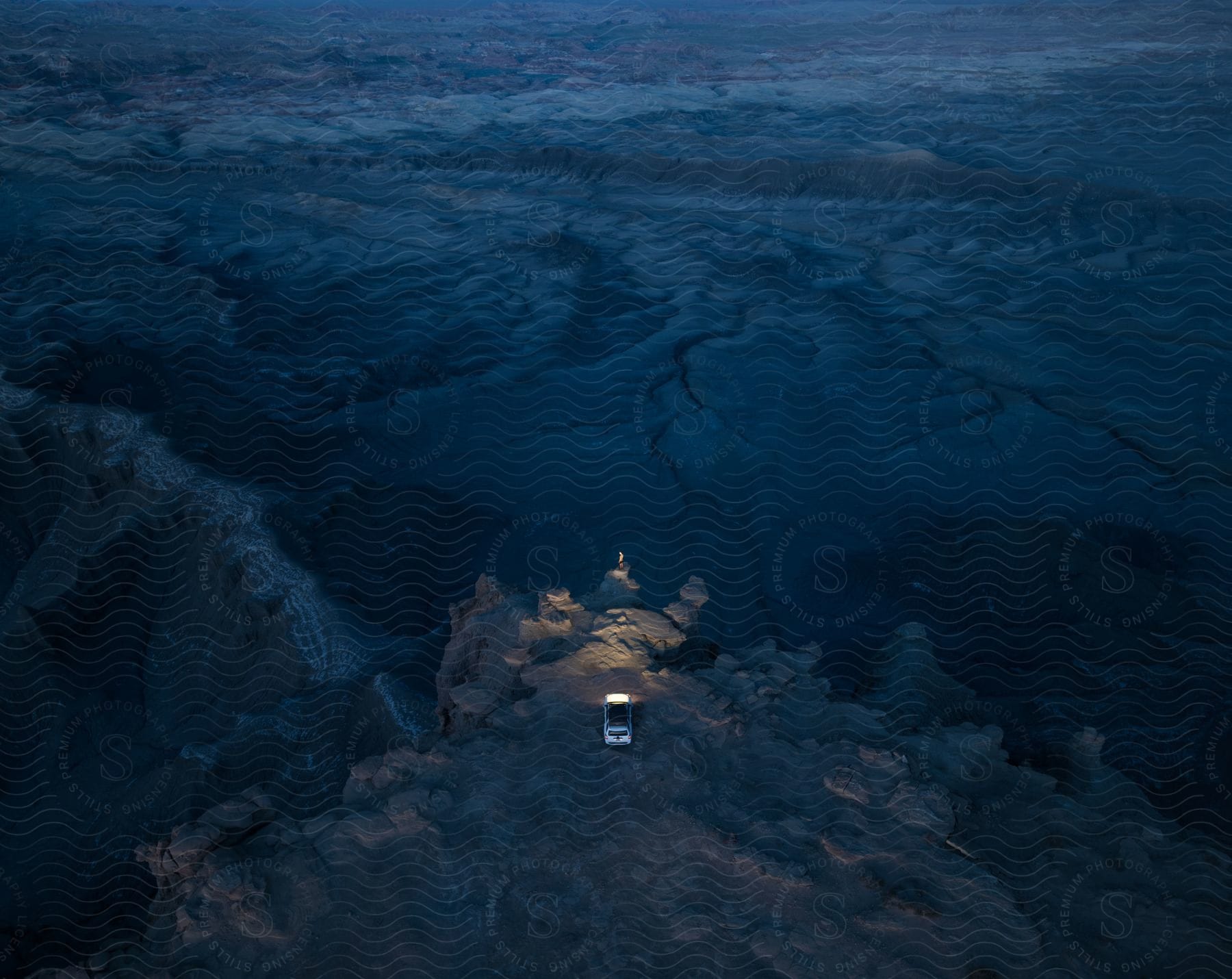 A bus parked on a vast land during the evening