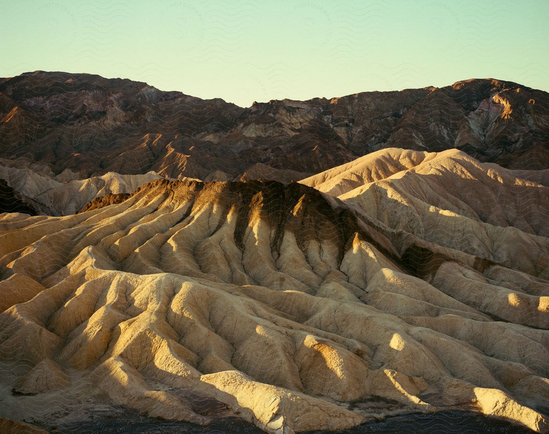 Fractal patterns in rock formations near a mountain in the evening