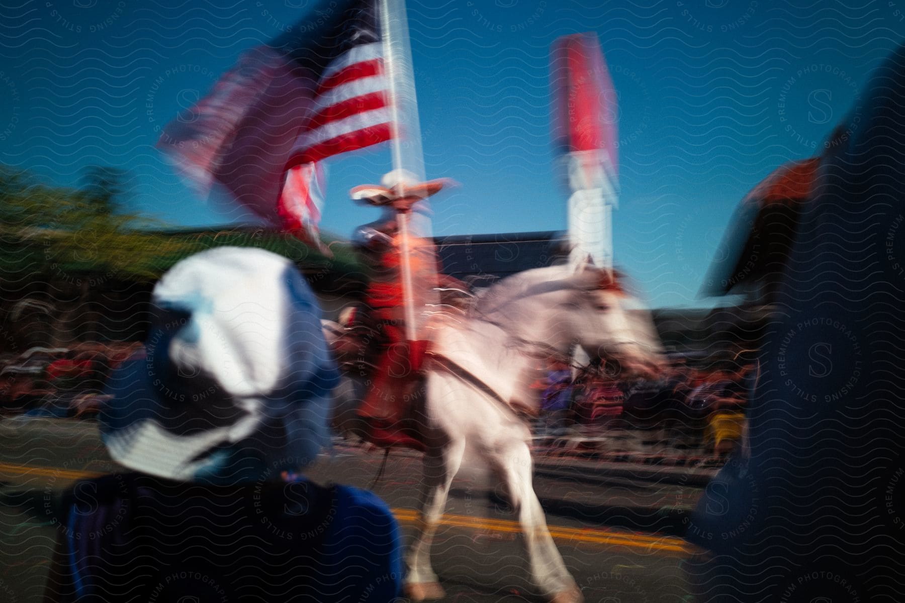 Blurred shot of people watching a parade in the streets