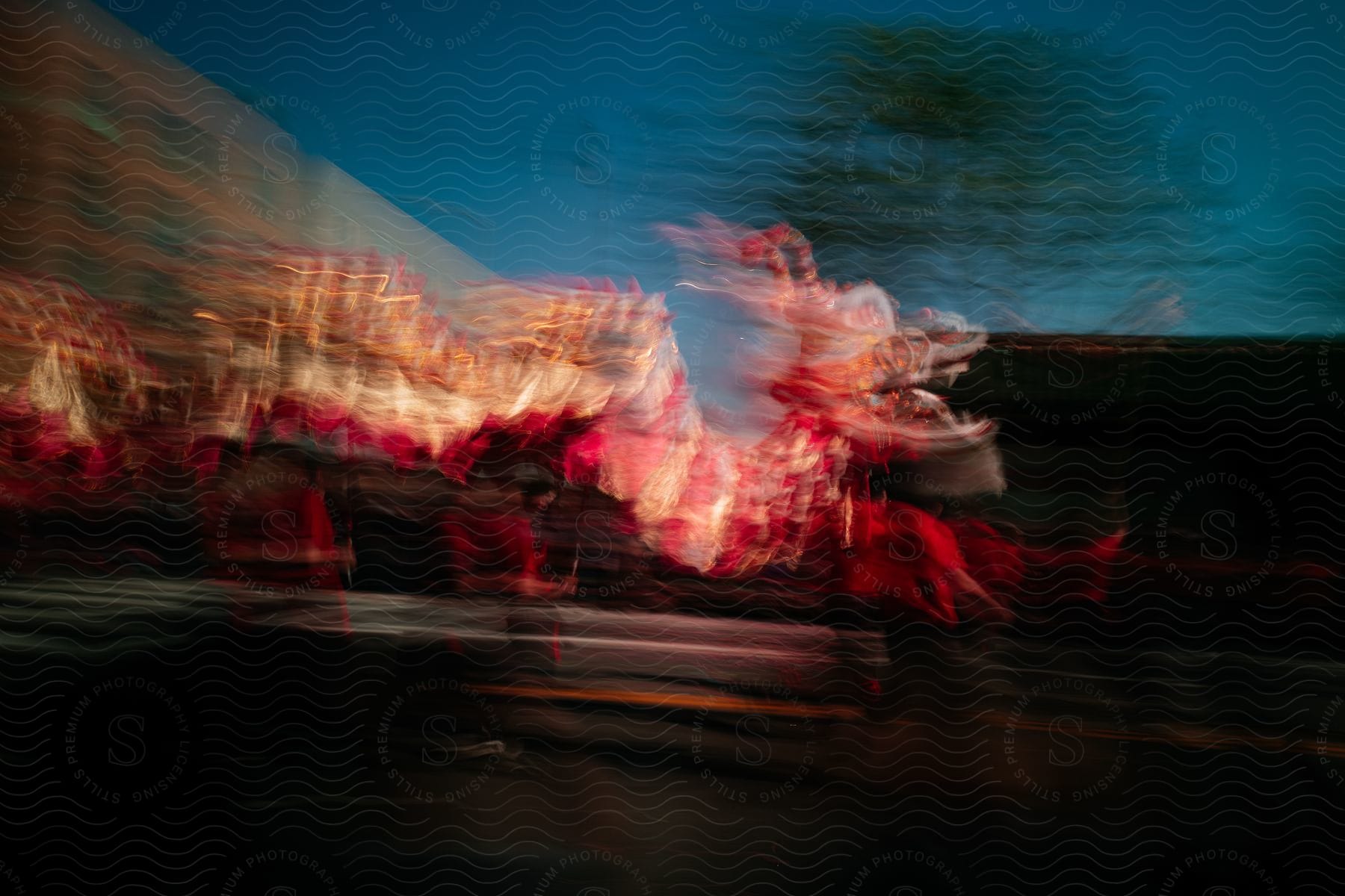 A chinese dragon dance taking place outdoors at night