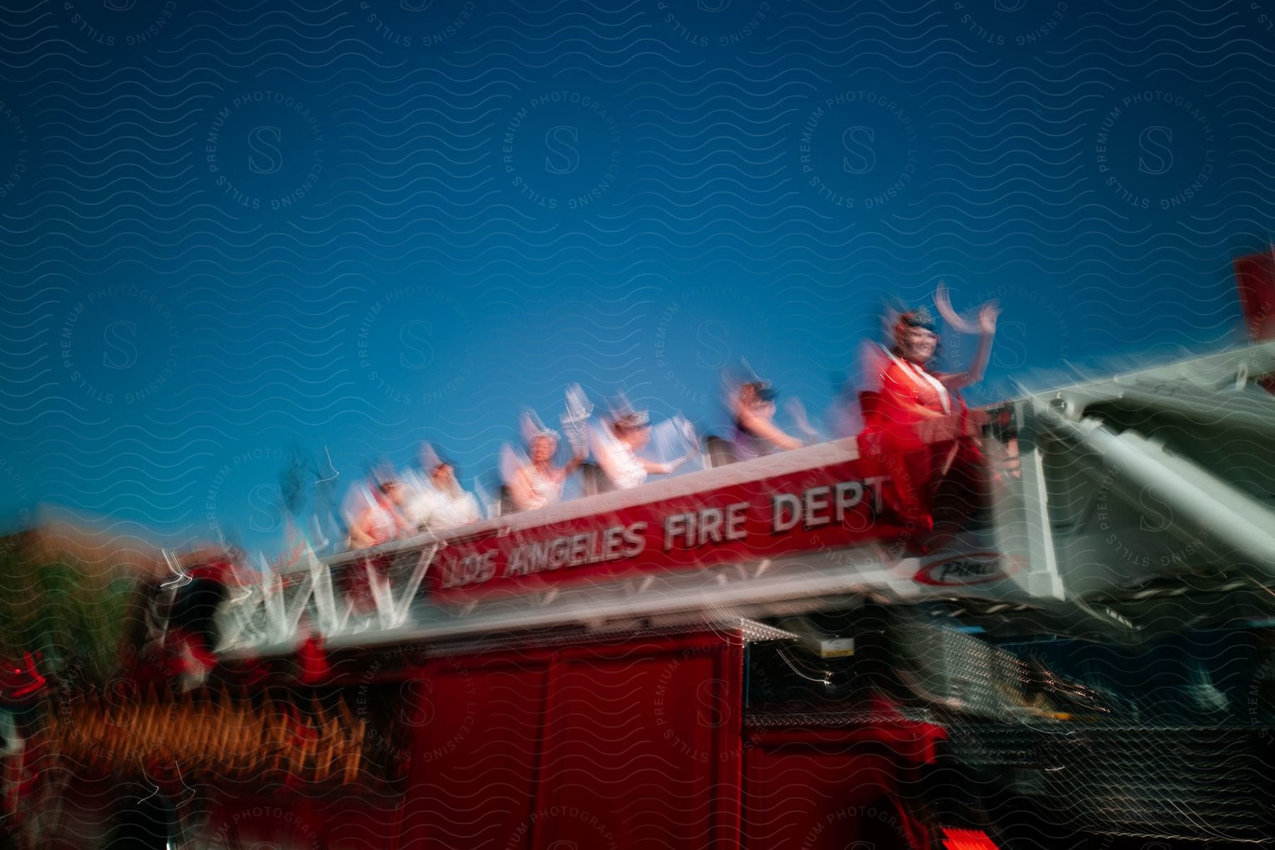 A blurred photo of a small group of people waving on a bus