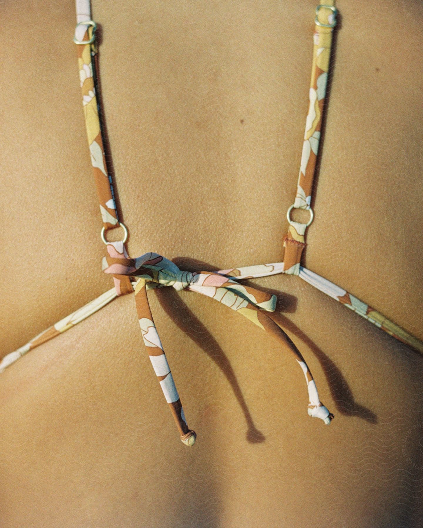 A person wearing eyewear and a necklace made of natural material