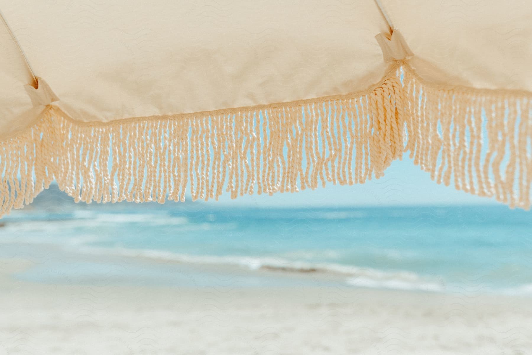 A tranquil morning by the beach with a calm sea and clear sky