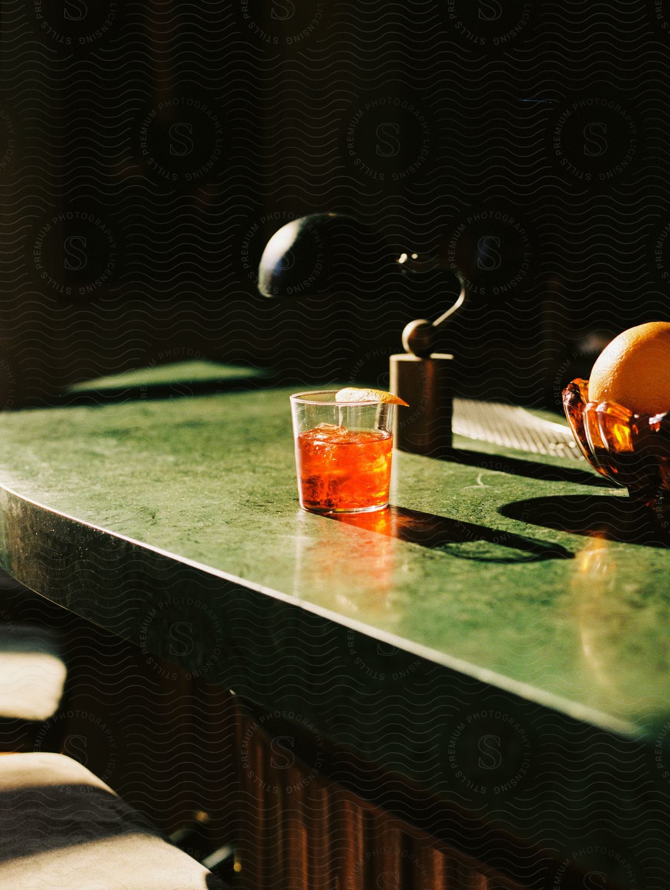 A beverage in a glass sits on a kitchen countertop.