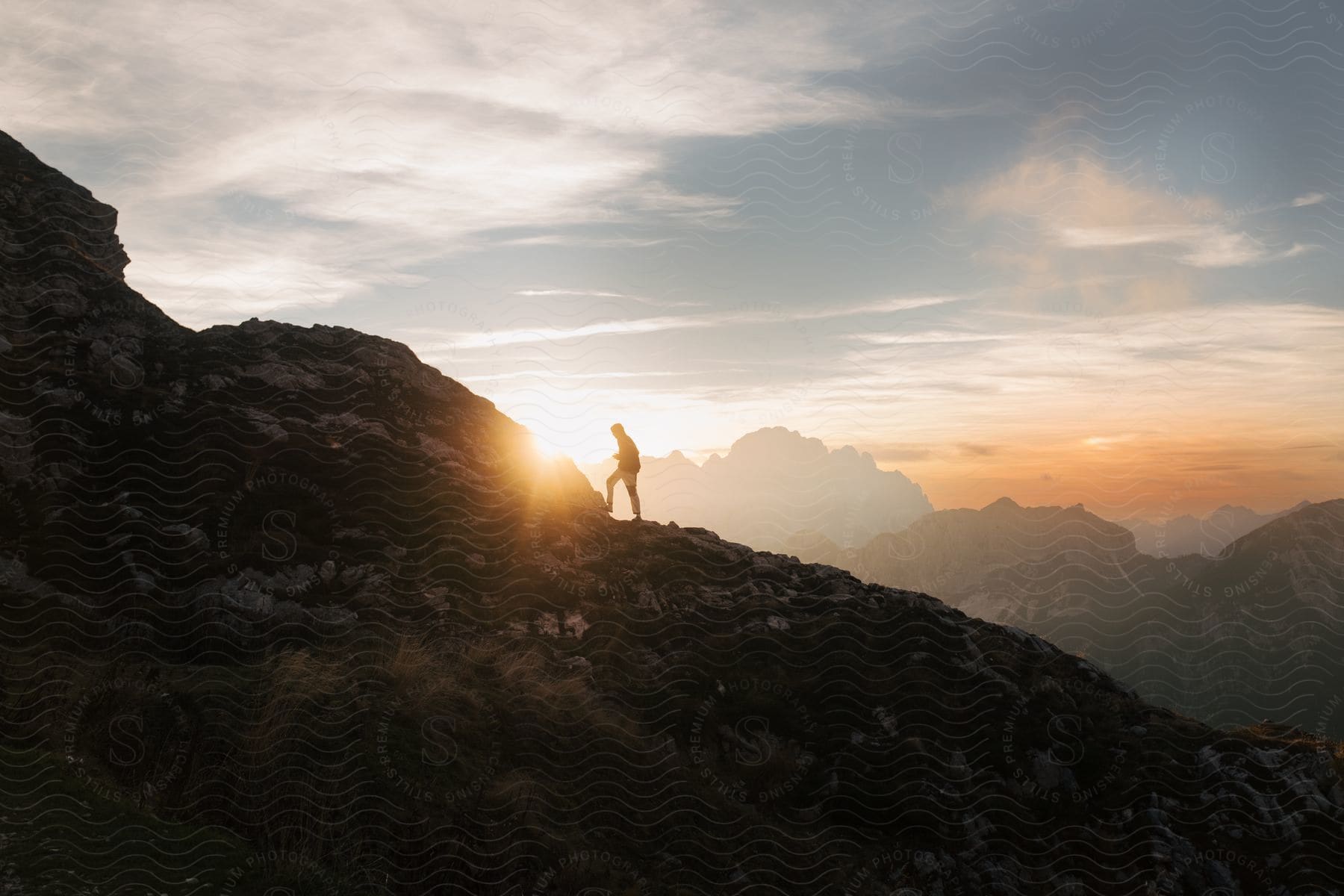 Person hiking high on a mountain at dusk or dawn in slovenia