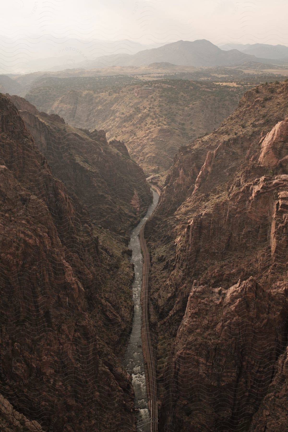 A road winds along a river in a mountain canyon in royal gorge canyon colorado