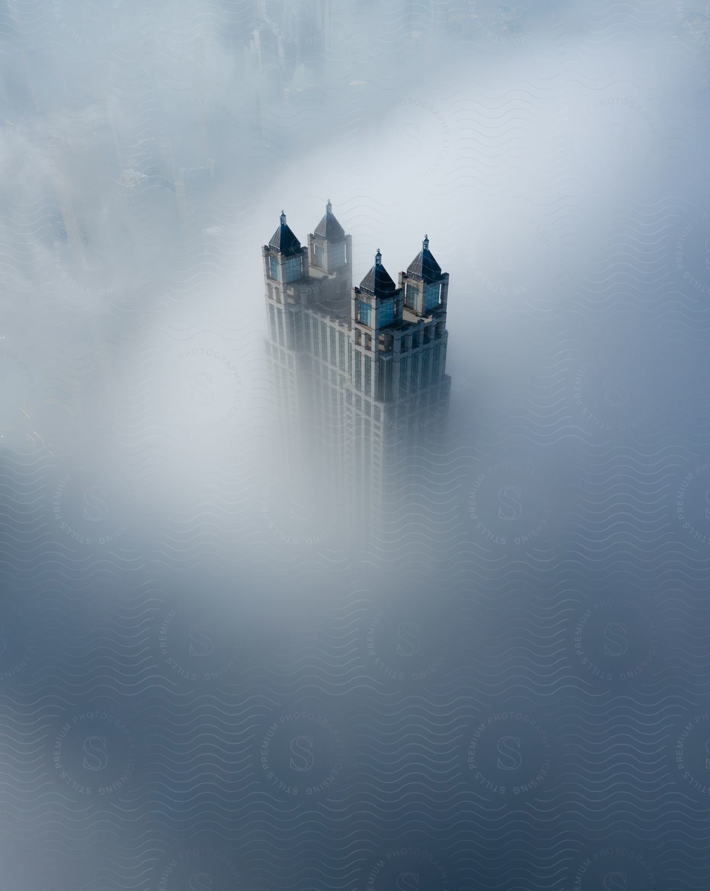 Fog and clouds surround a skyscraper in chicago
