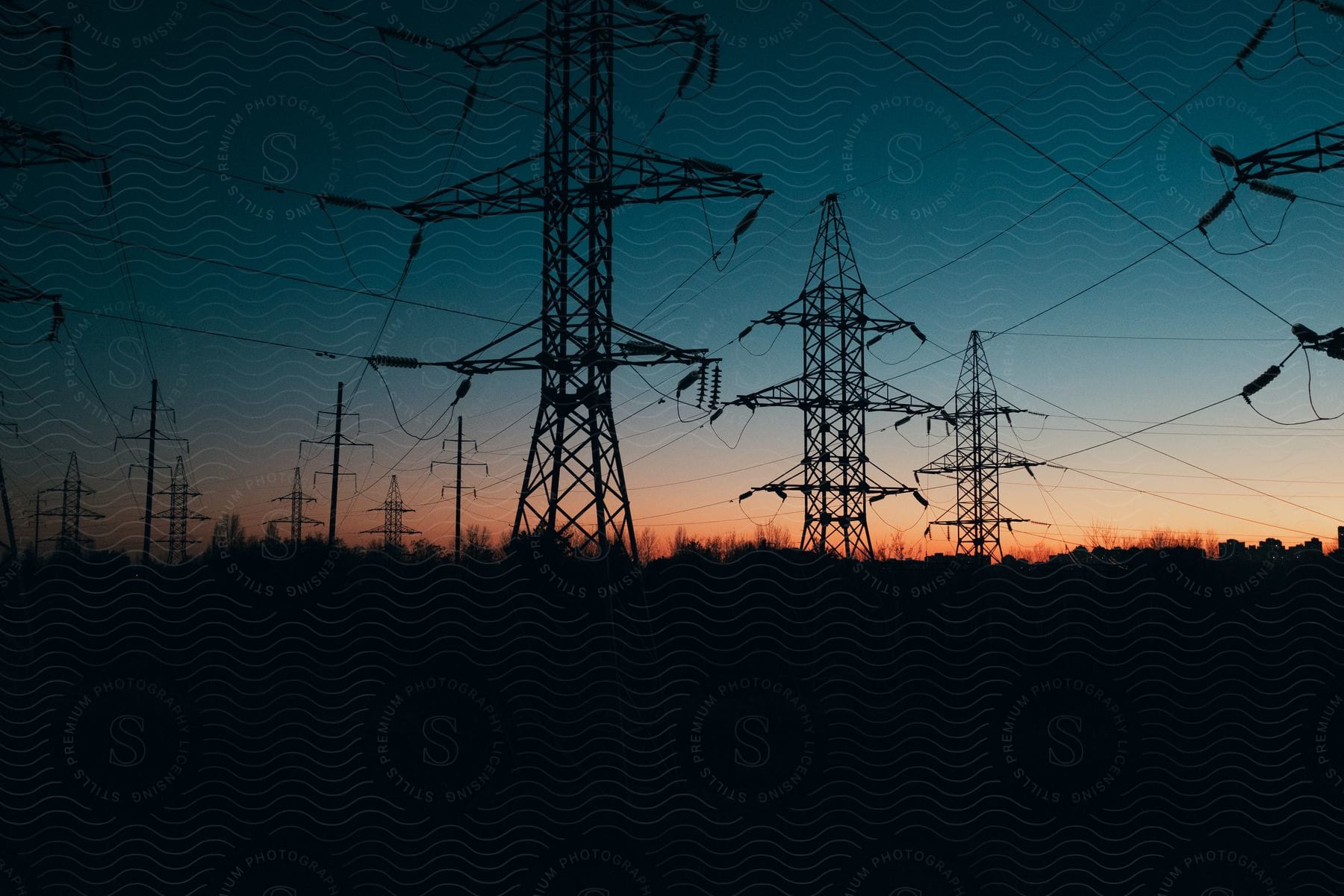 Electrical towers and power lines at dusk