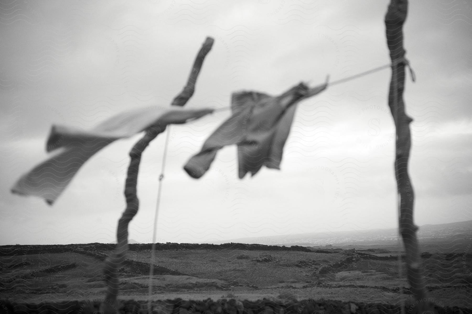 Clothes dry on a makeshift laundry line outside