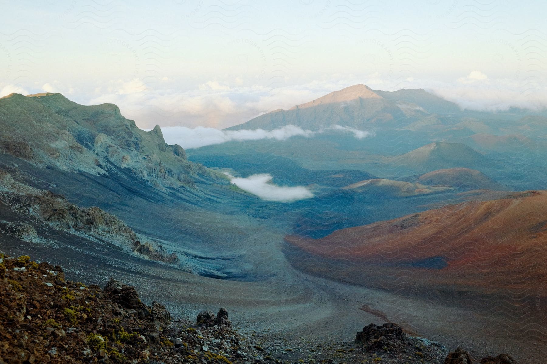 Landscape of haleakalā east maui volcano in haleakalā national park maui showing mountains terrain and a cloudy sky