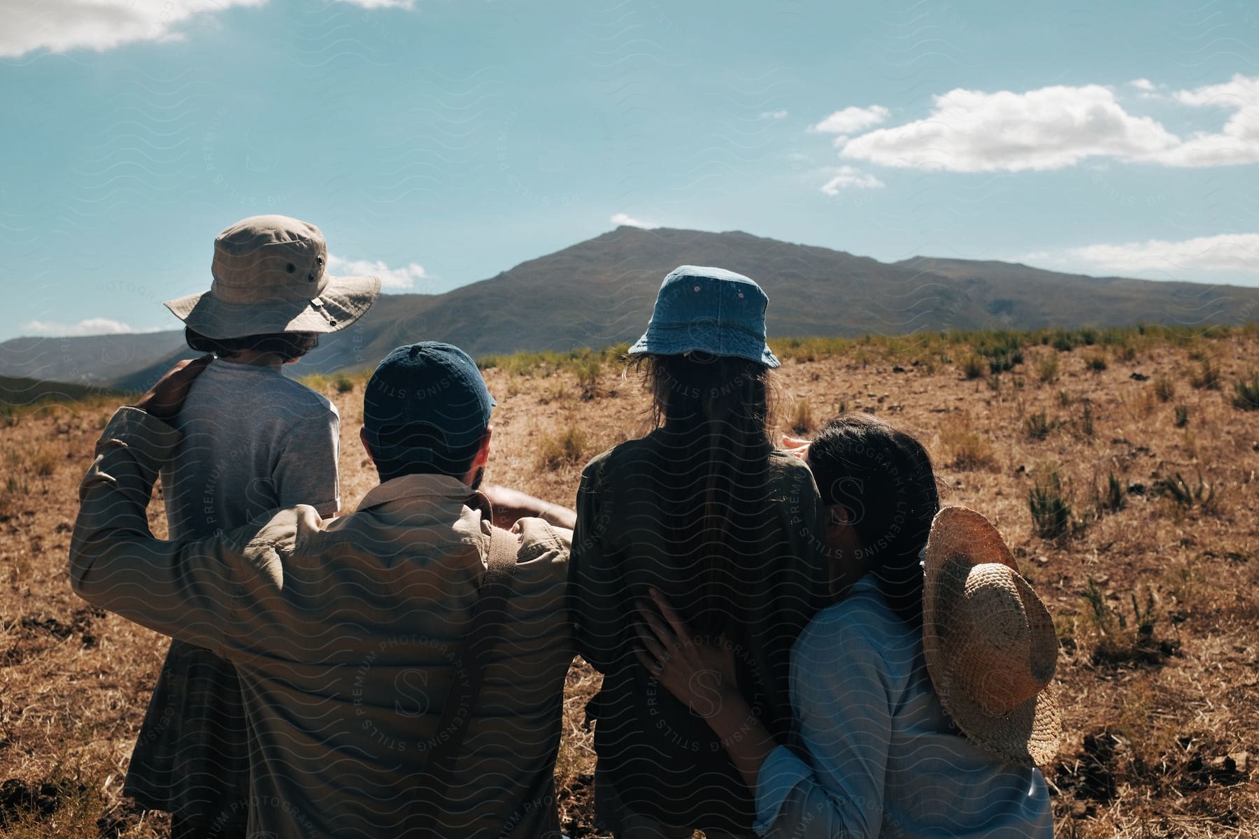 Family standing on field looking at mountains in distance