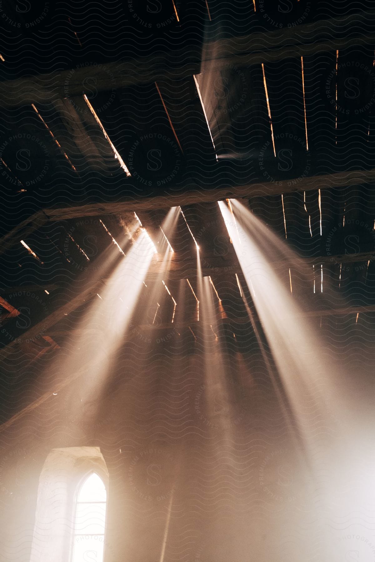 Light streams through the slats of a wooden roof