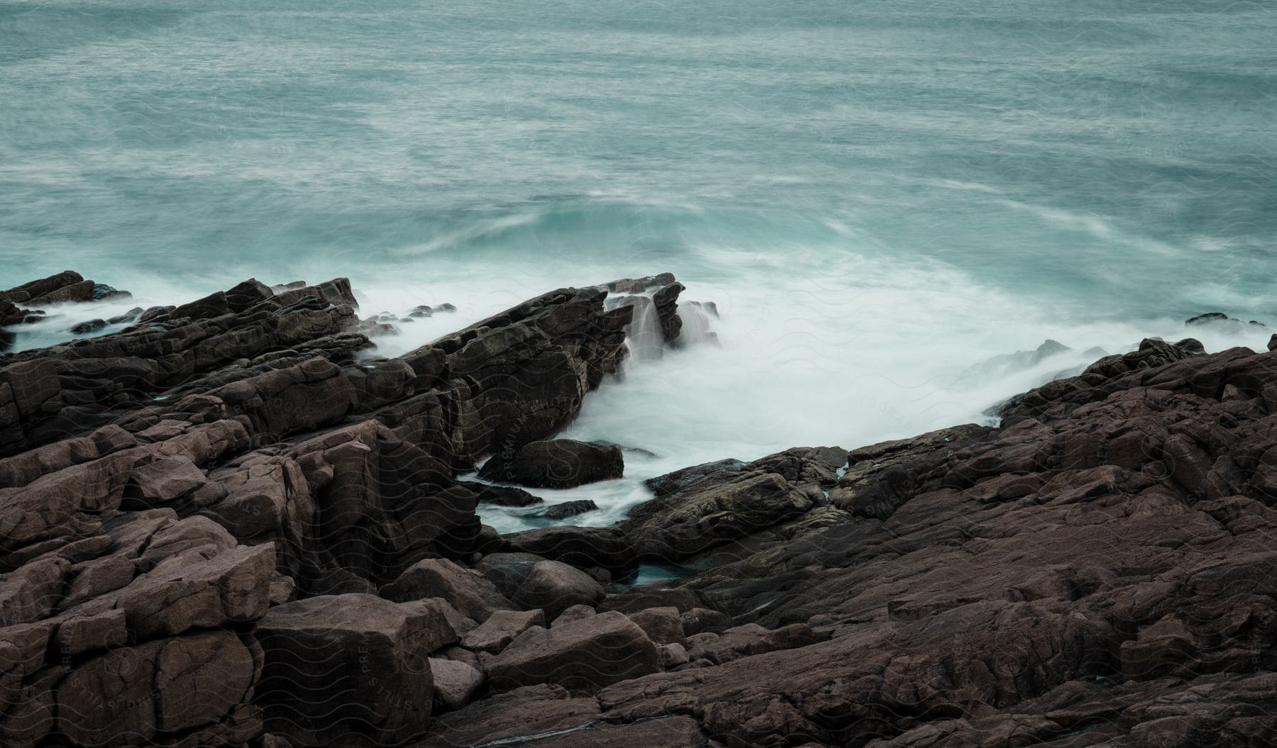 Ocean Waves Breaking Against The Rocky Shore