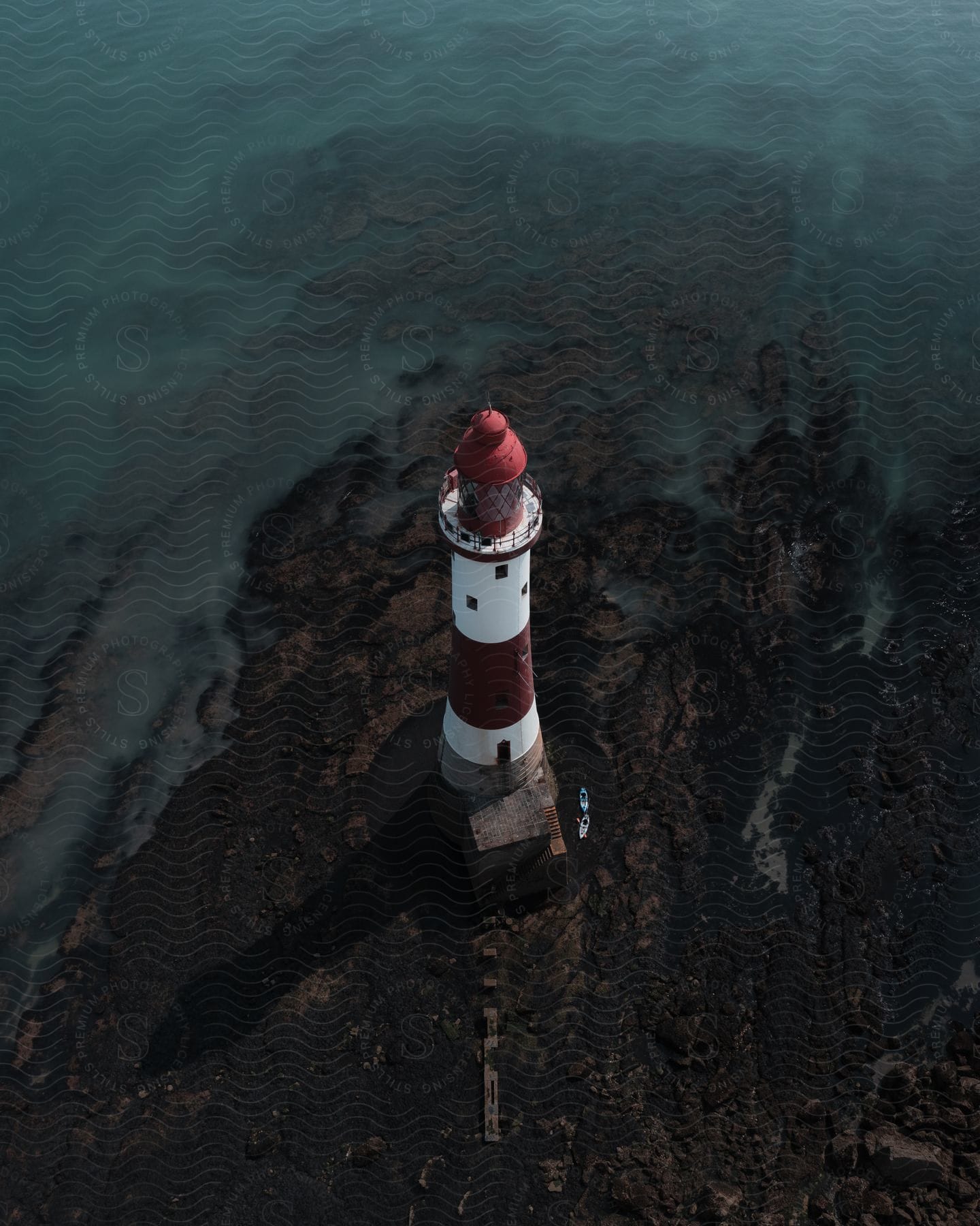 Aerial shot of a coastal lighthouse near the ocean