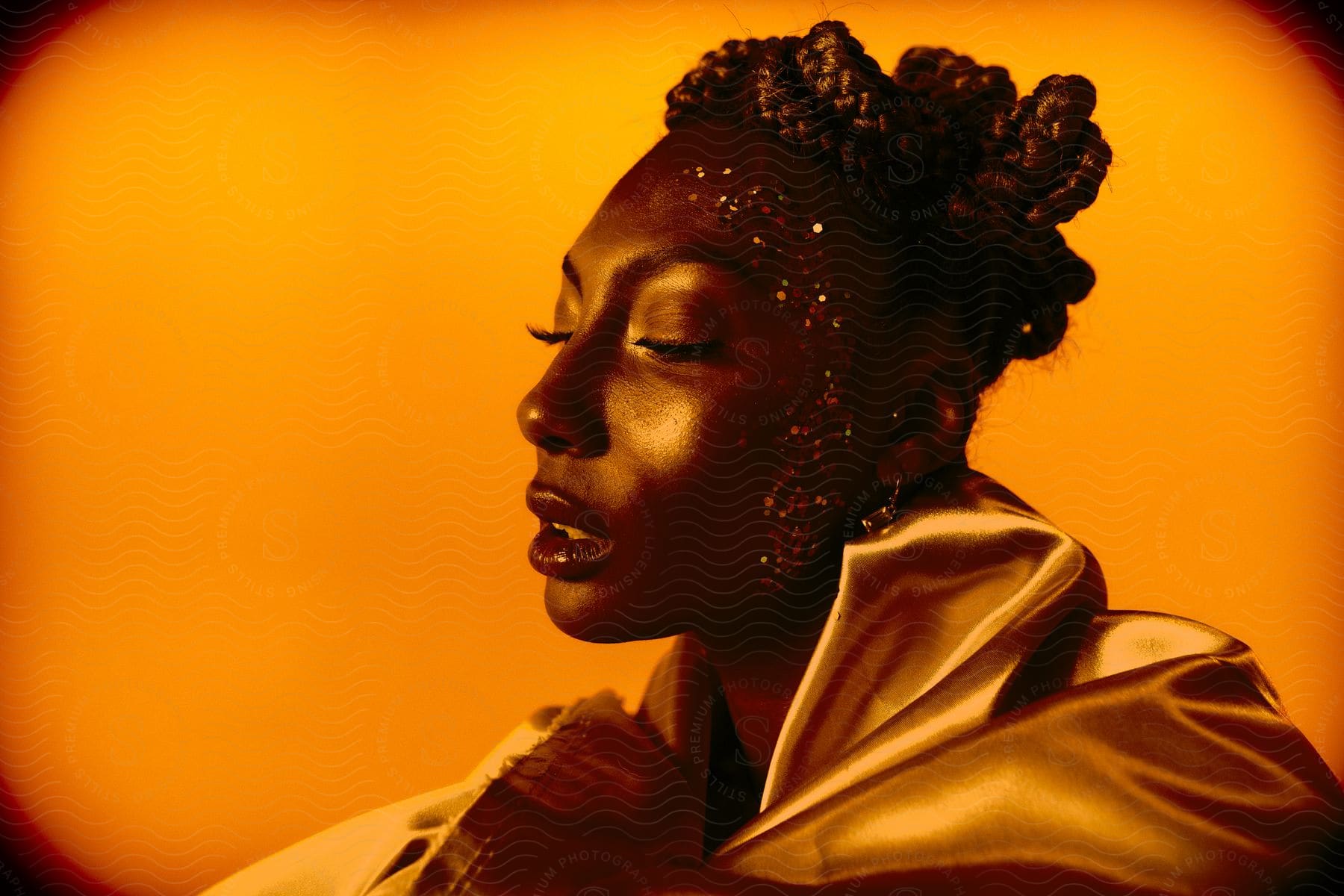 Woman posing with golden light illuminating her face in the gold room