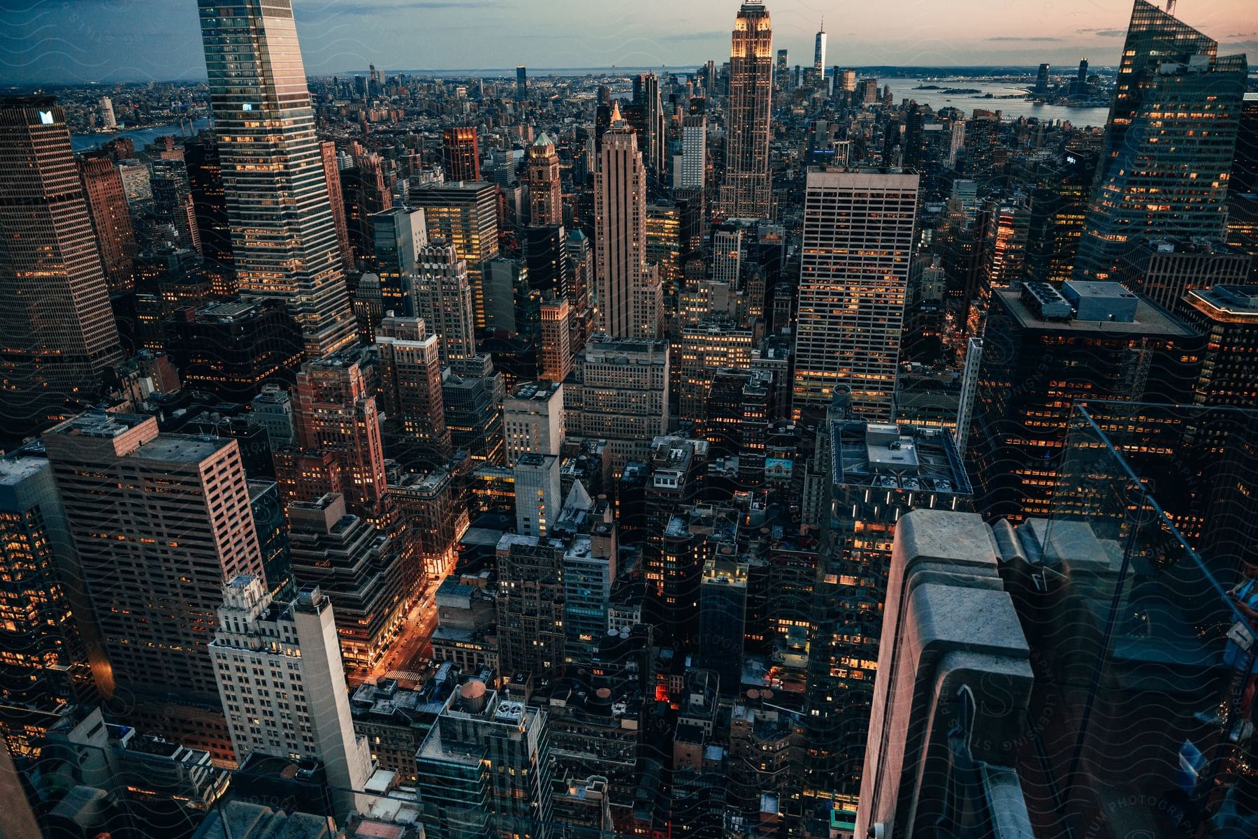 A Sunset In A Large Metropolitan City With Skyscrapers And City Lights