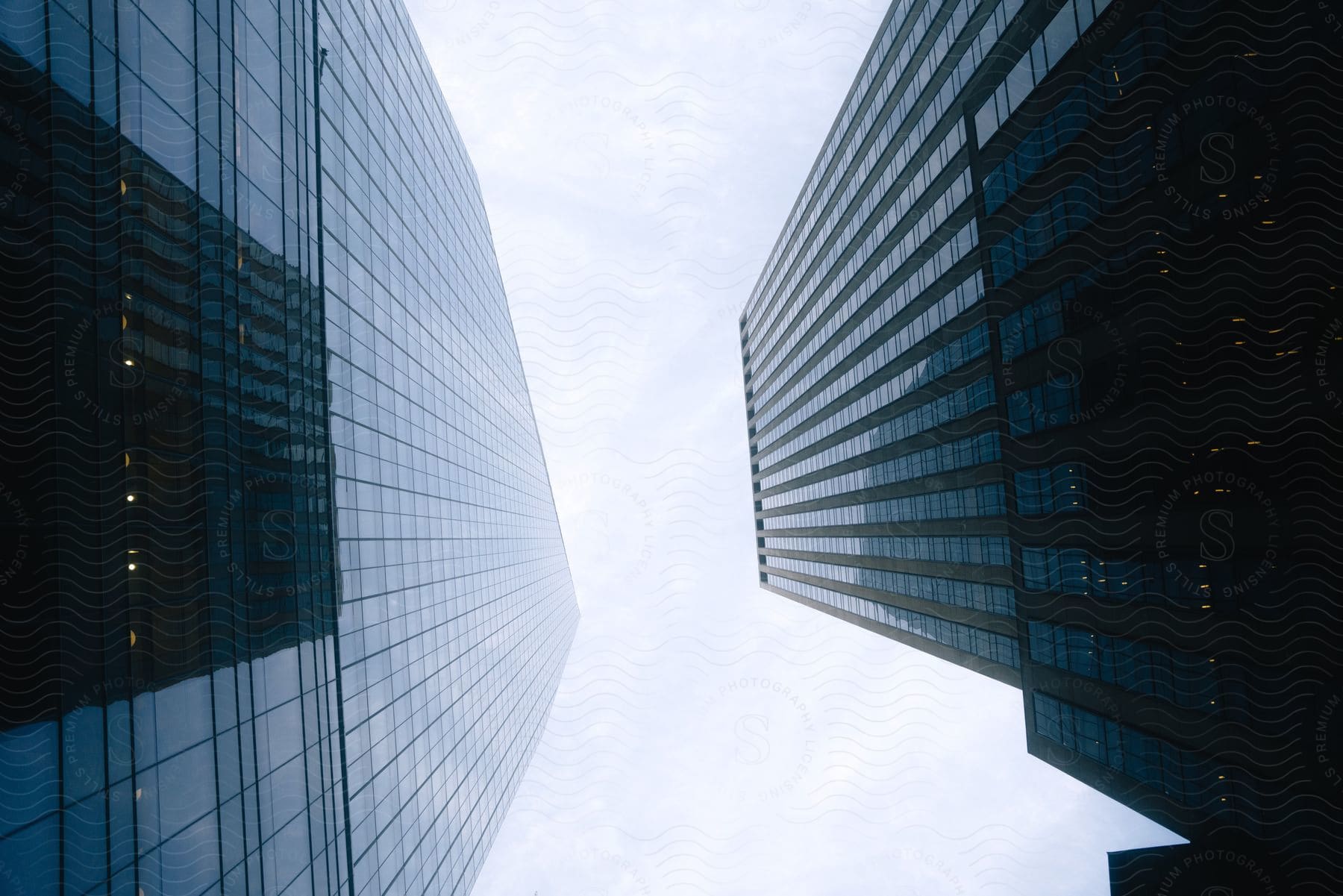 The sky is visible between two skyscrapers in new york city during the day