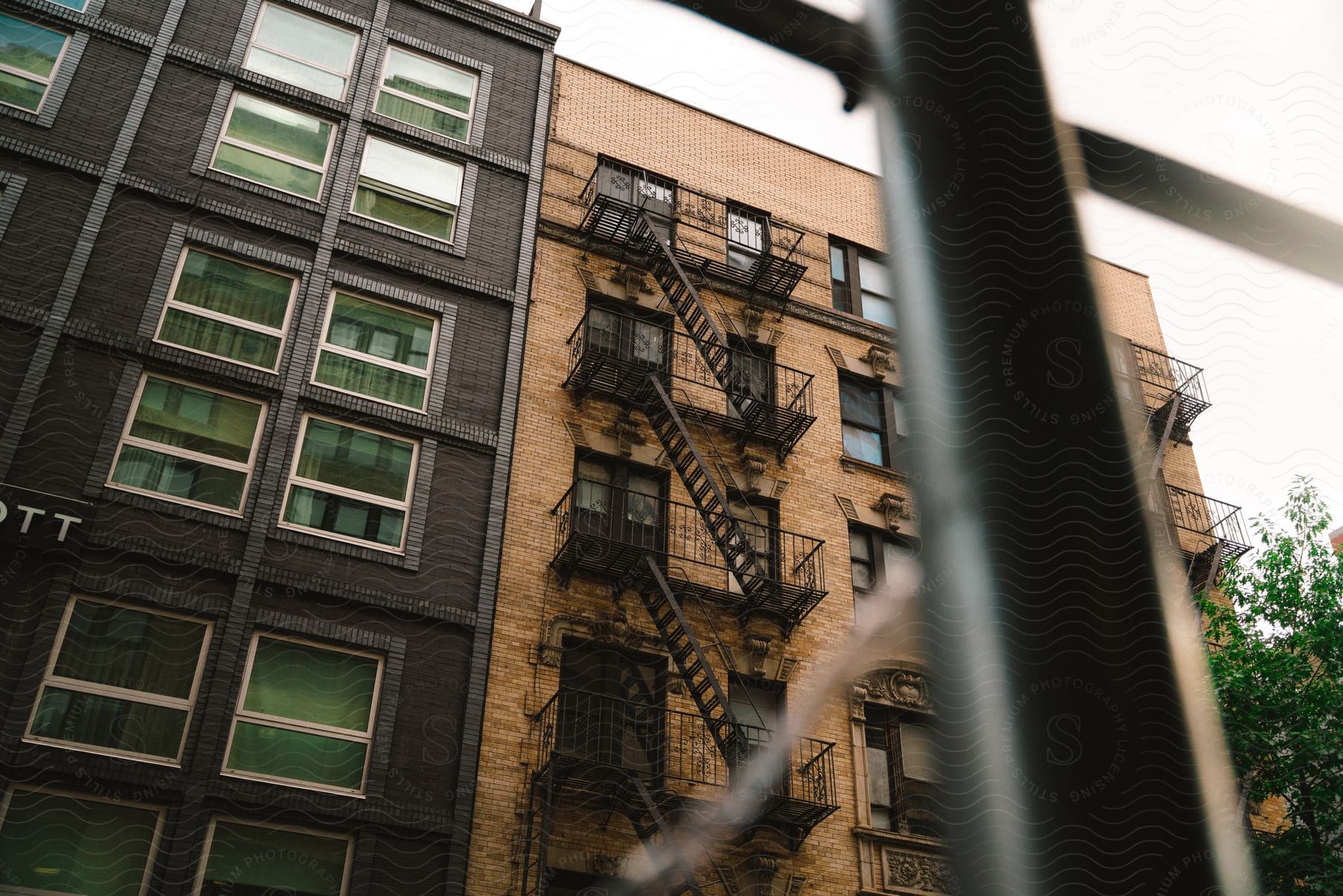Fire escape of a condo building seen from a neighboring window on a cloudy day