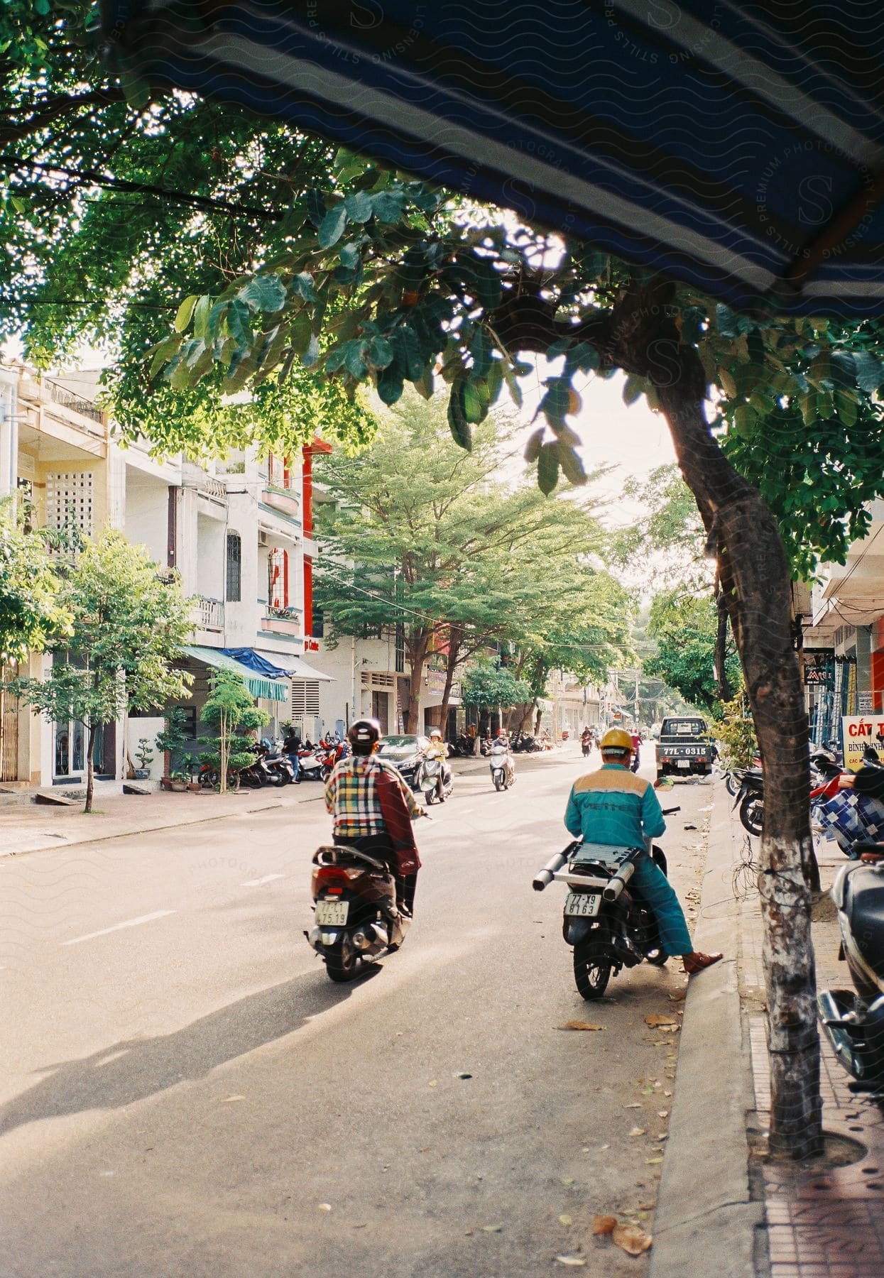 Urban landscape with vehicles and people passing by on a busy street in vietnam