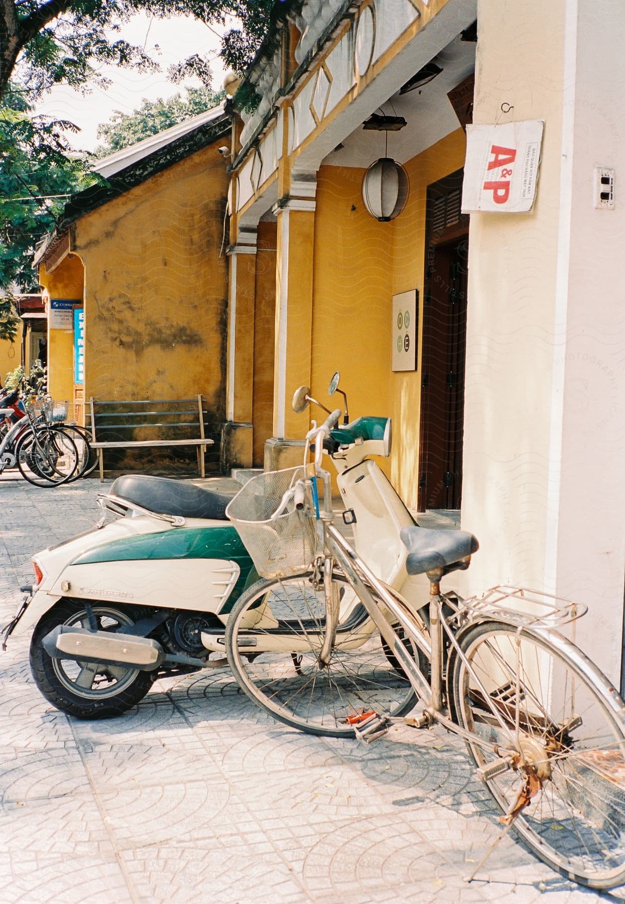 A motorcycle and a bicycle parked next to each other in front of a bar