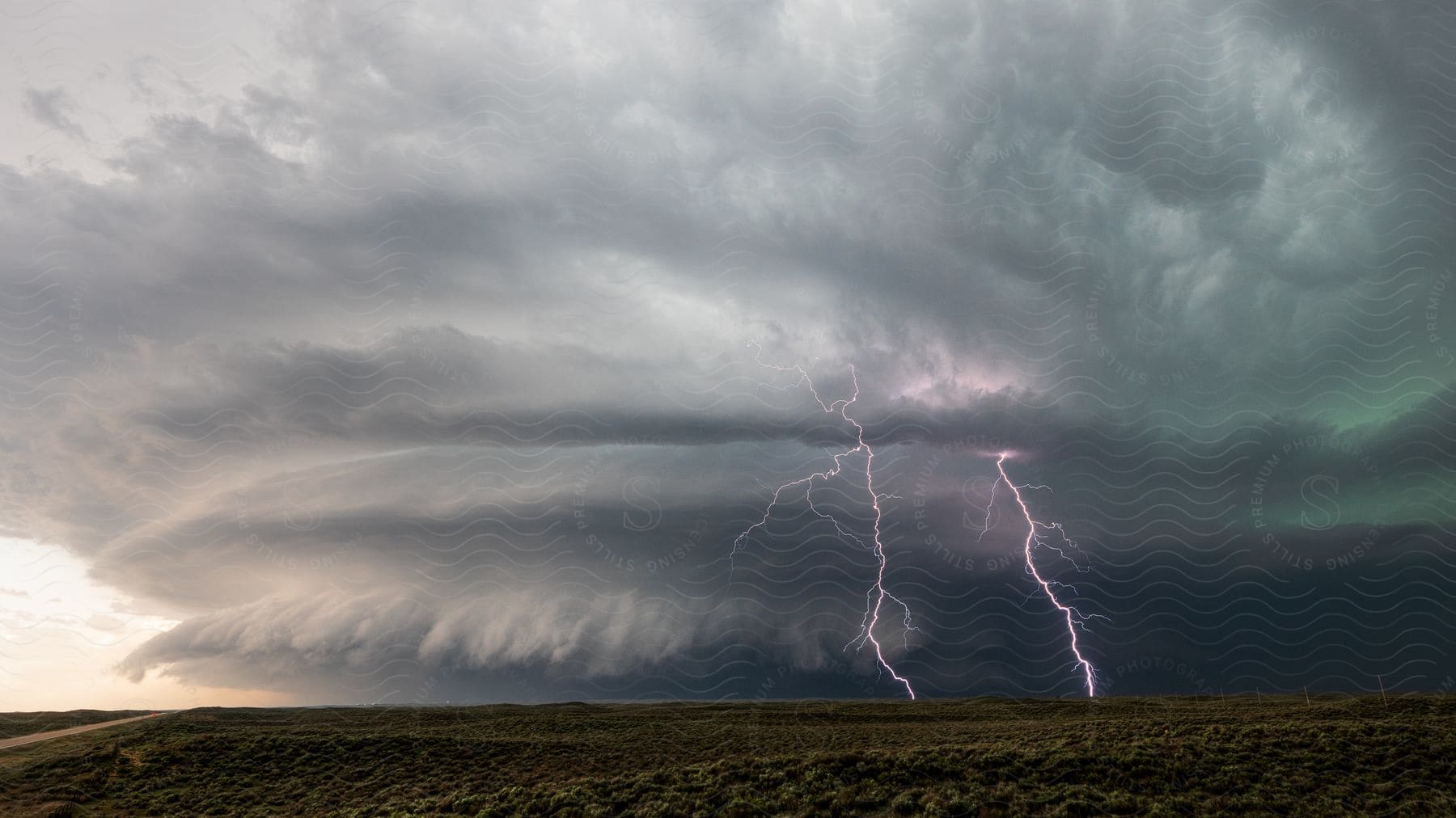 Lightning and rain falling from storm clouds over the plains