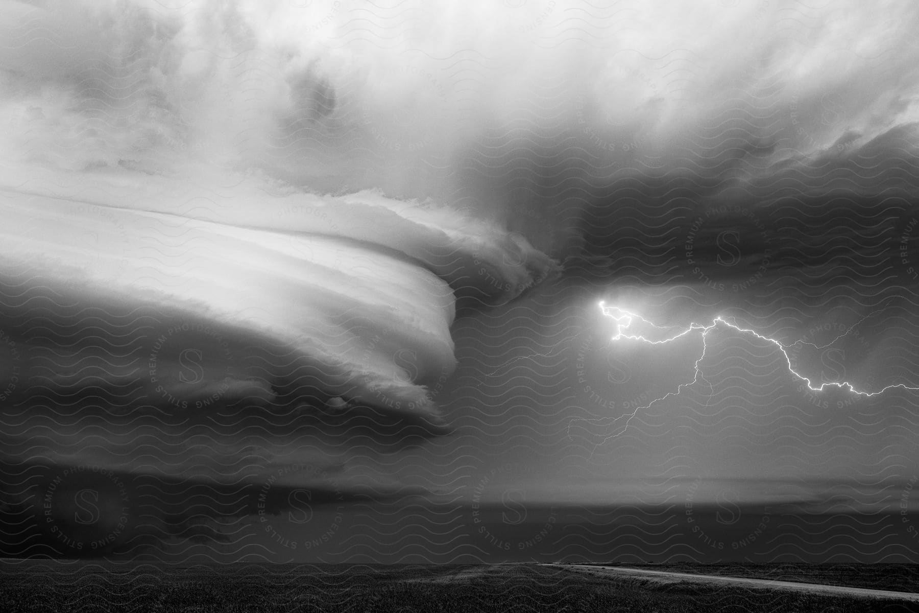 A blackandwhite photograph of a heavy lightning storm over the nebraska landscape near wauneta