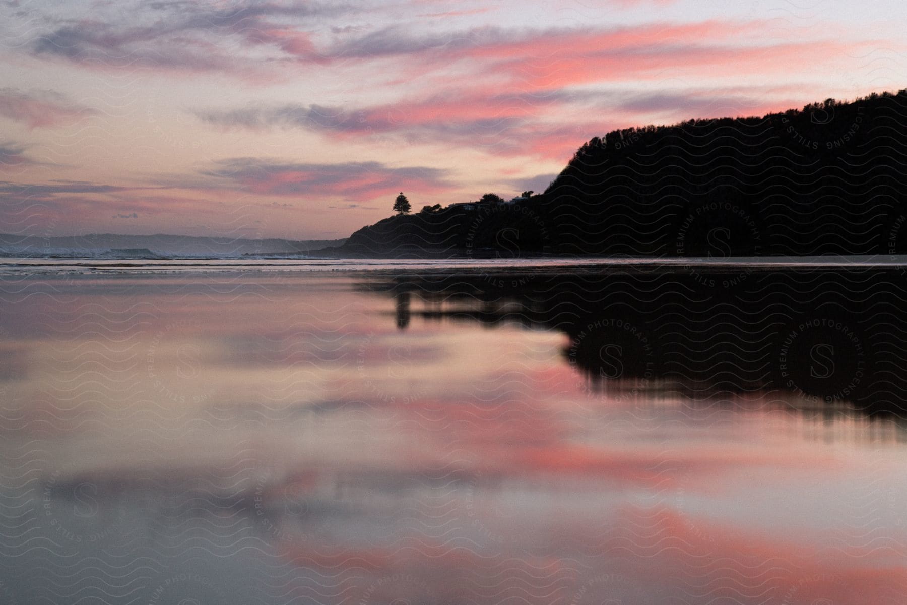 A serene sunset over a tranquil shoreline