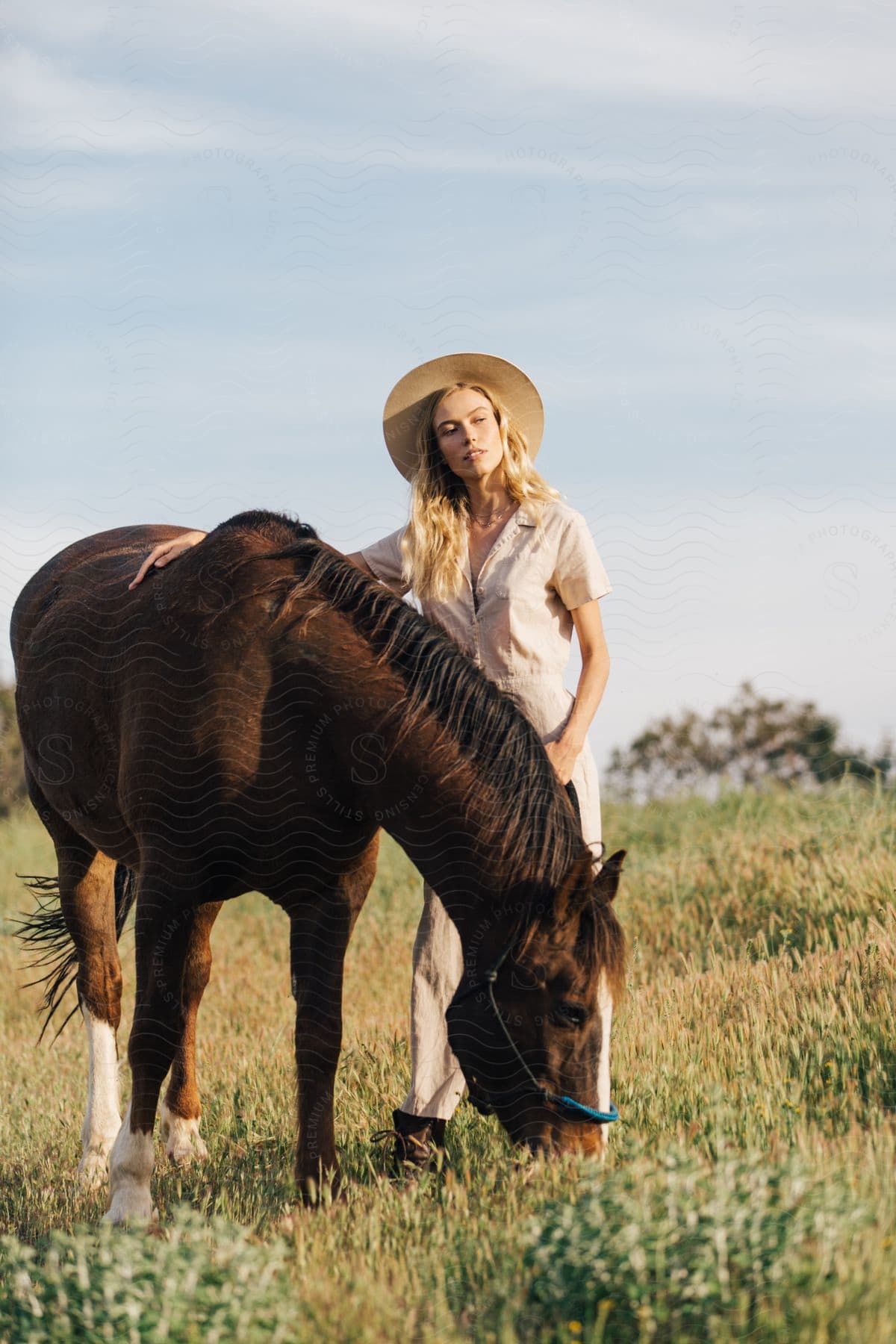 A woman standing outdoors with her horse in malibu mountains