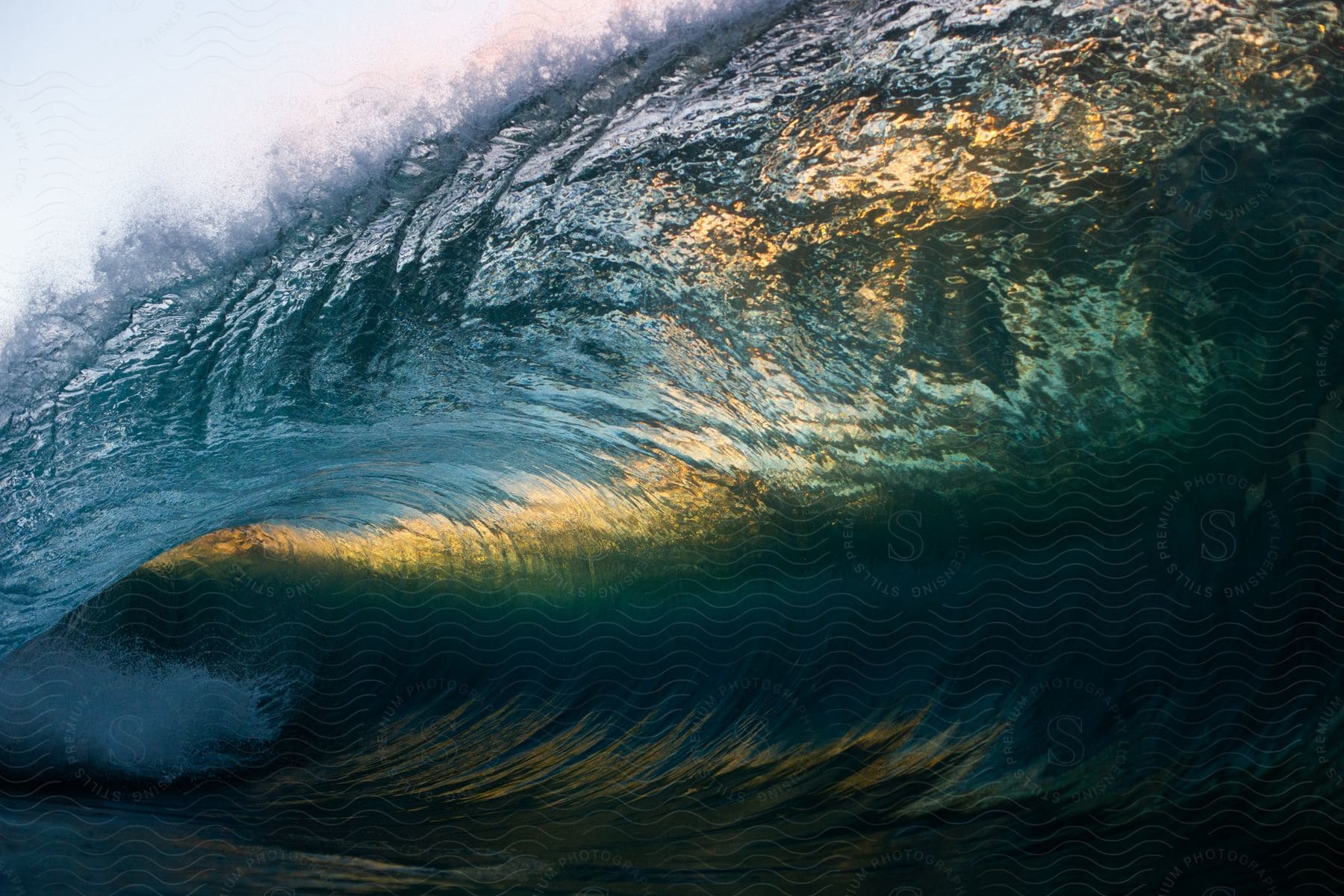 A Clear Wave With The Setting Sun Reflecting Through From Above