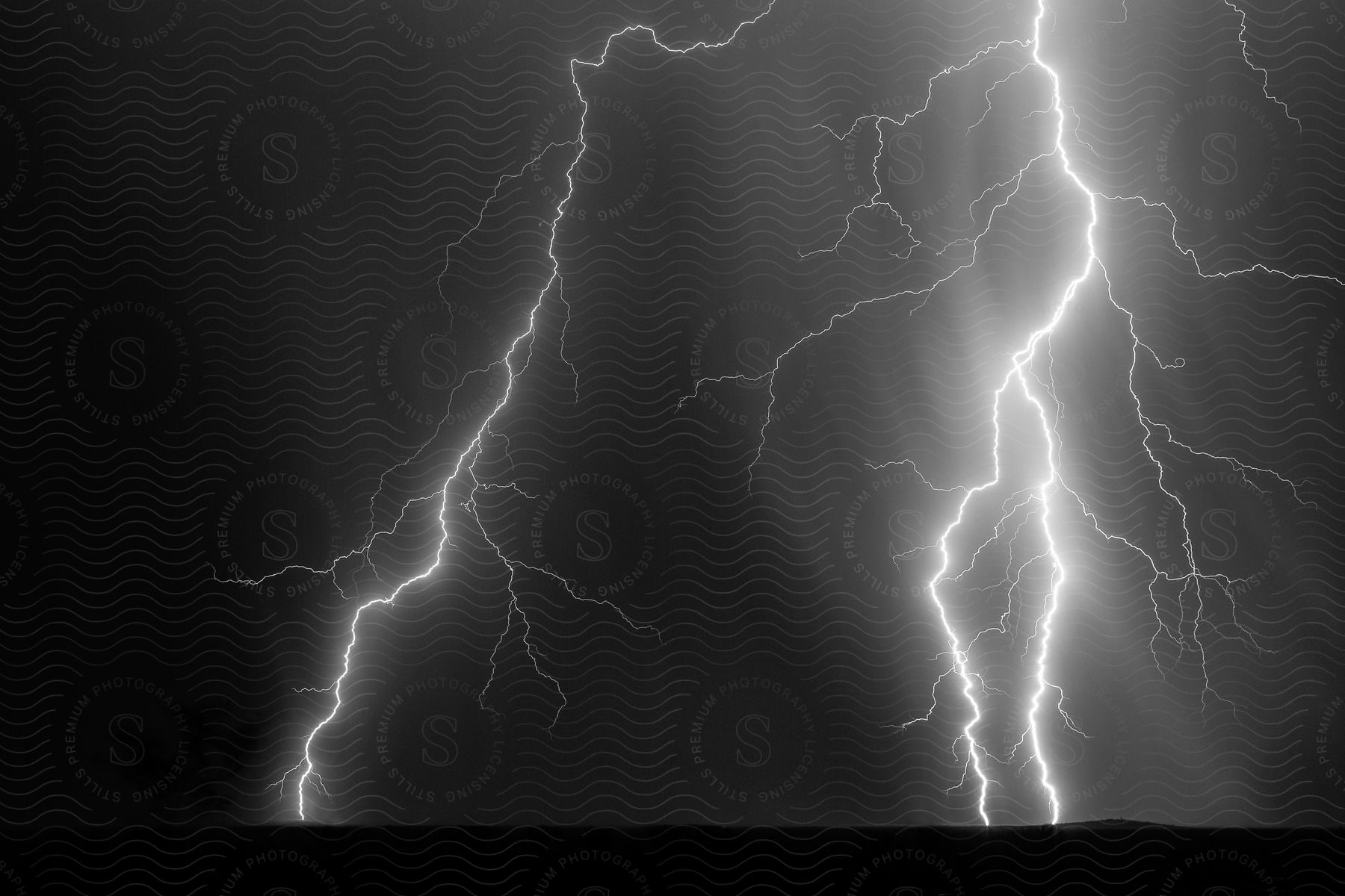 Black and white shot of lightning striking a field at night in three points arizona