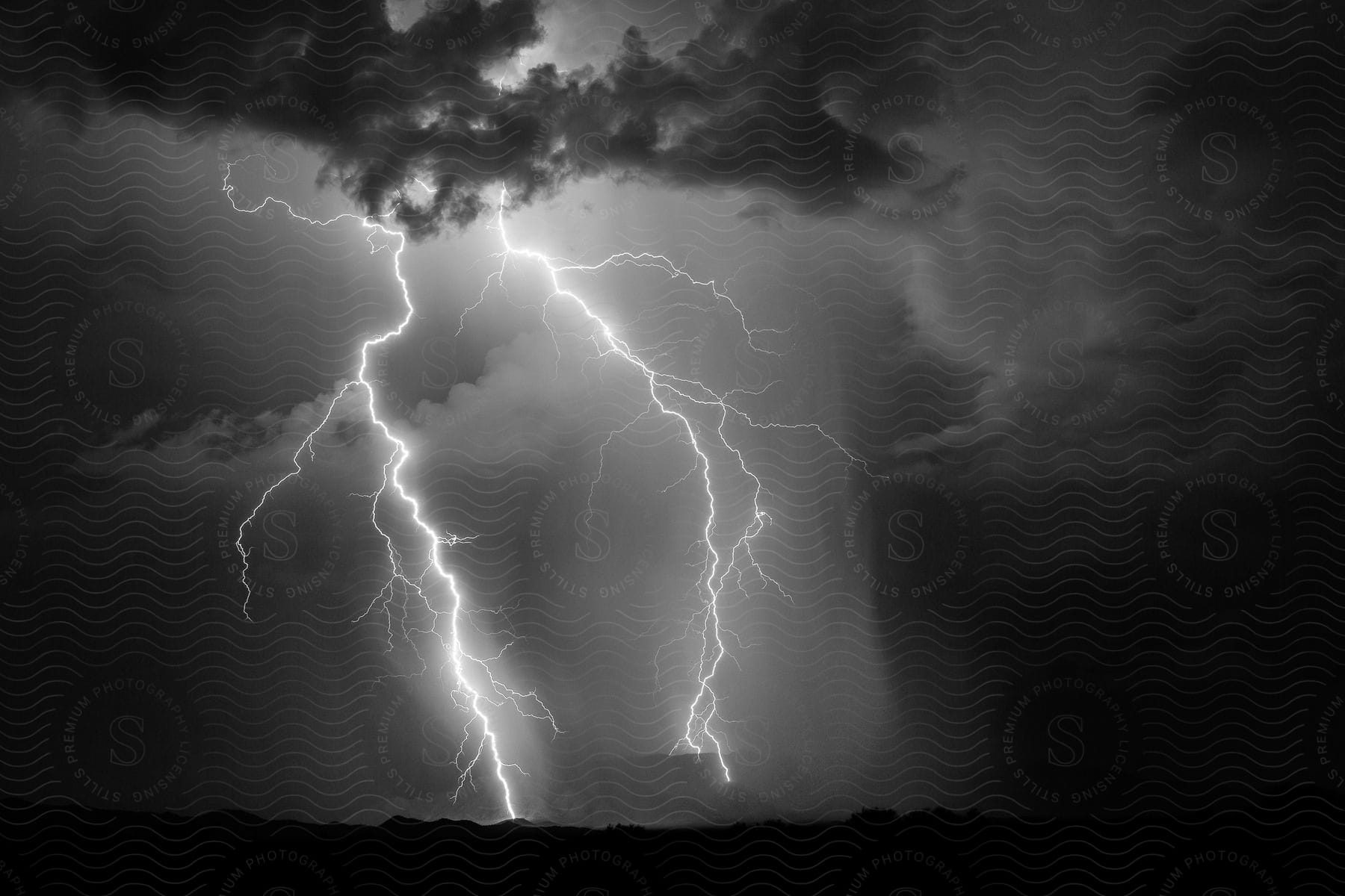 Black and white photo of lightning striking the ground in an unknown mountain range southwest of vekol valley road during a thunderstorm in arizona