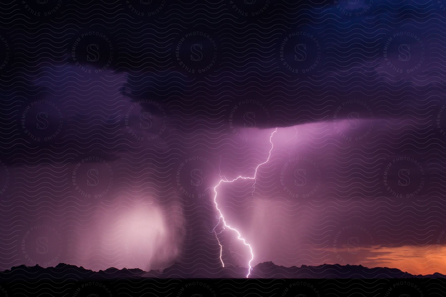 A lightning bolt strikes near triple eye and courthouse rock during a thunderstorm