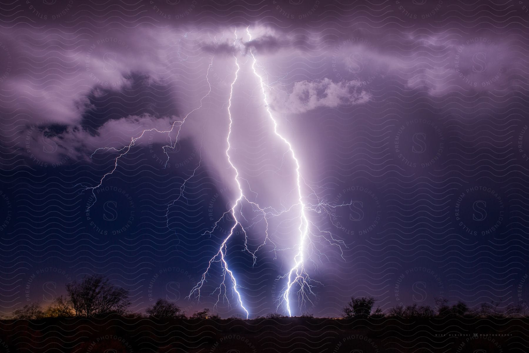 A lightning strikes the ground at night during a storm in arizona