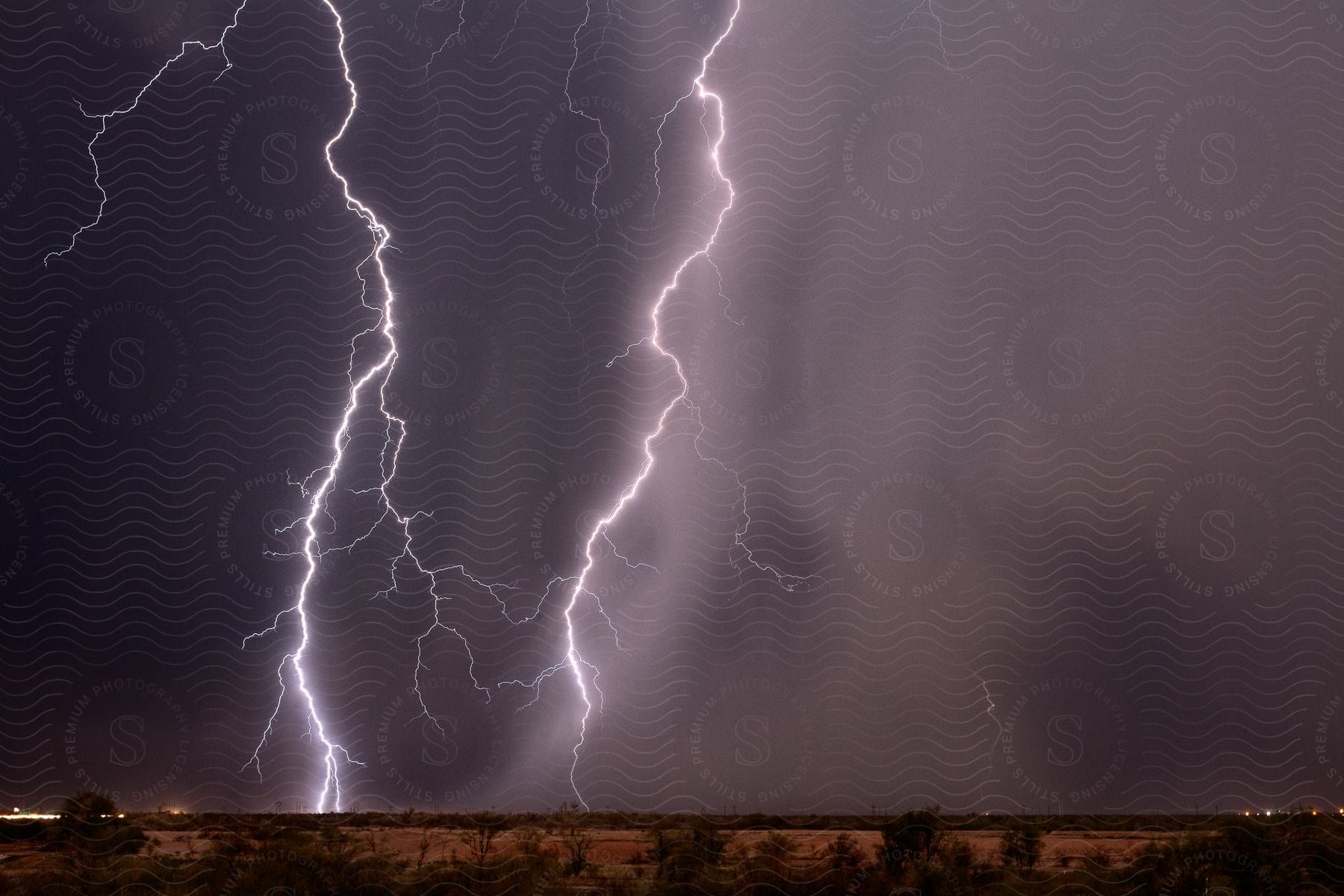 A powerful lightning strike in a natural landscape during a thunderstorm