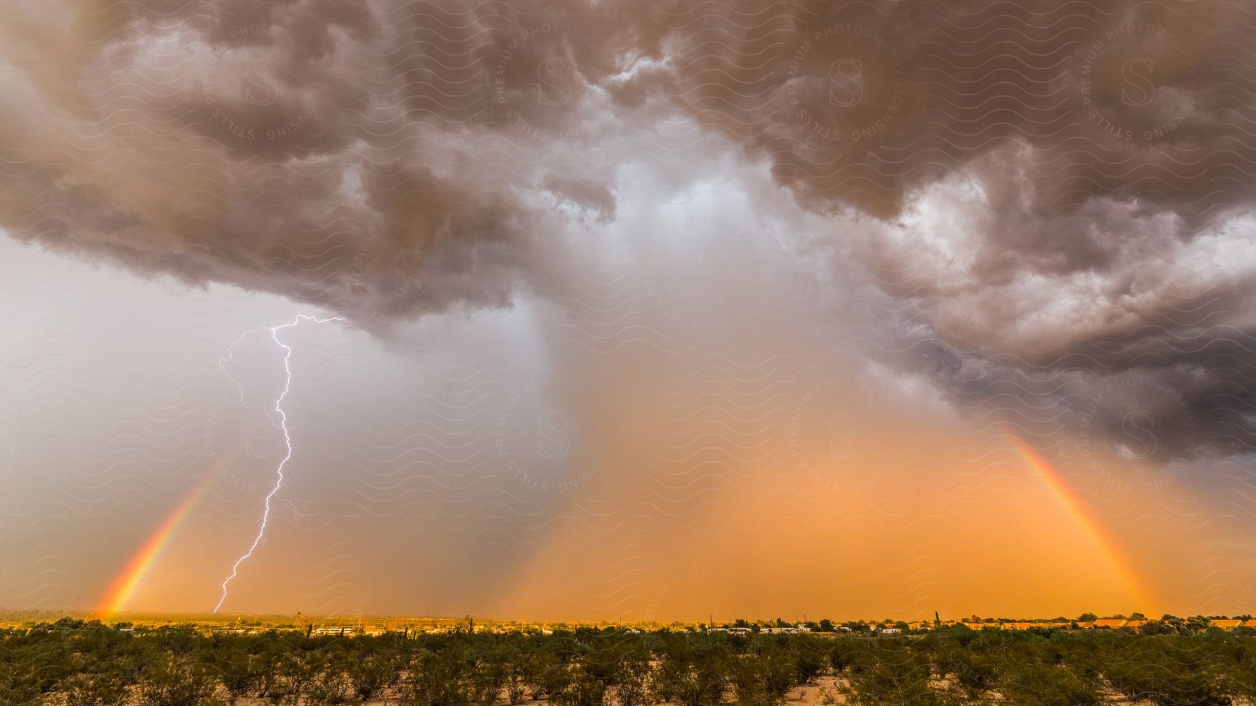 A rainbow and downdraft with lightning during a thunderstorm