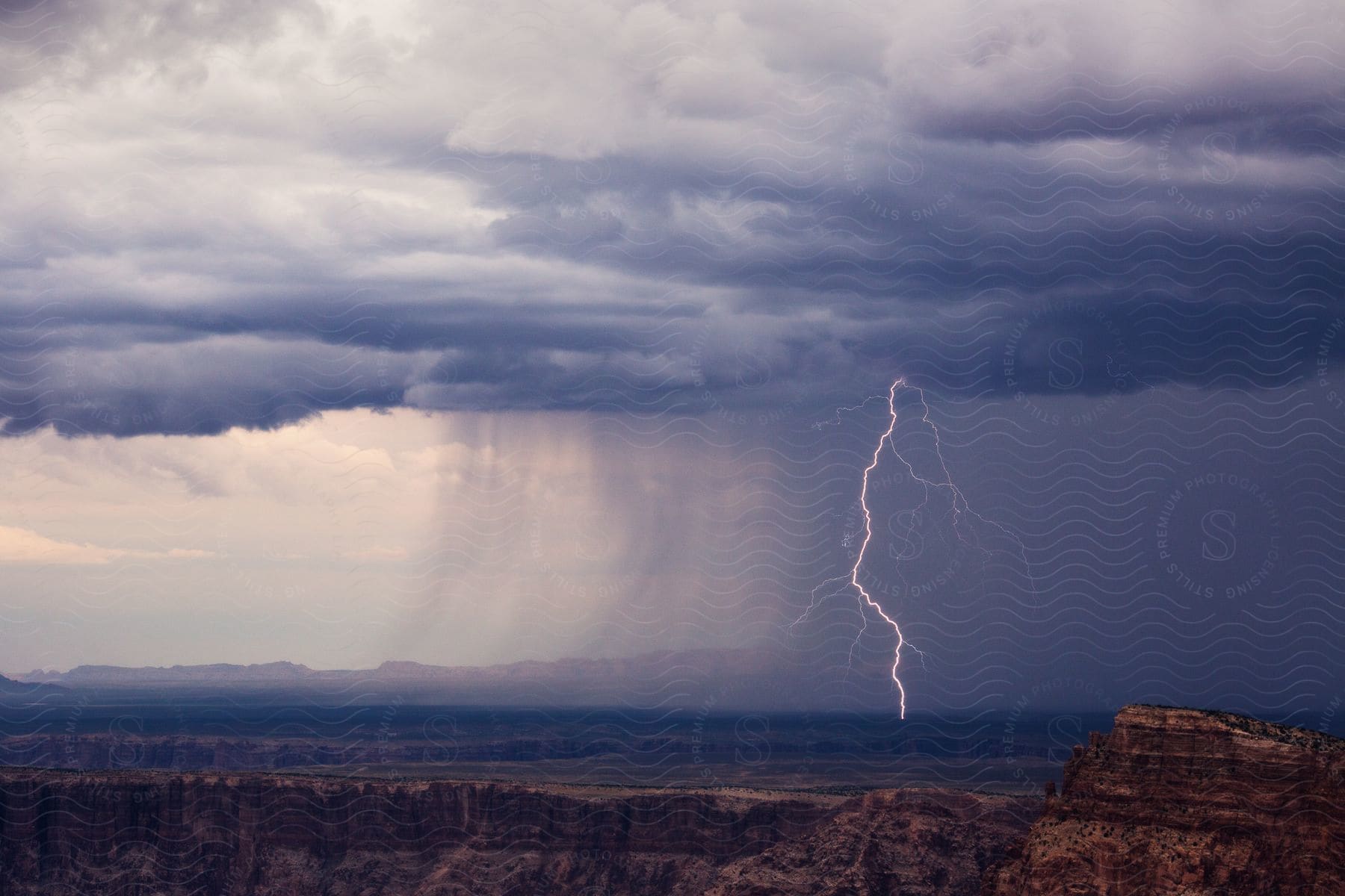 A cloudy sky with a thunder strike over a land at dawn