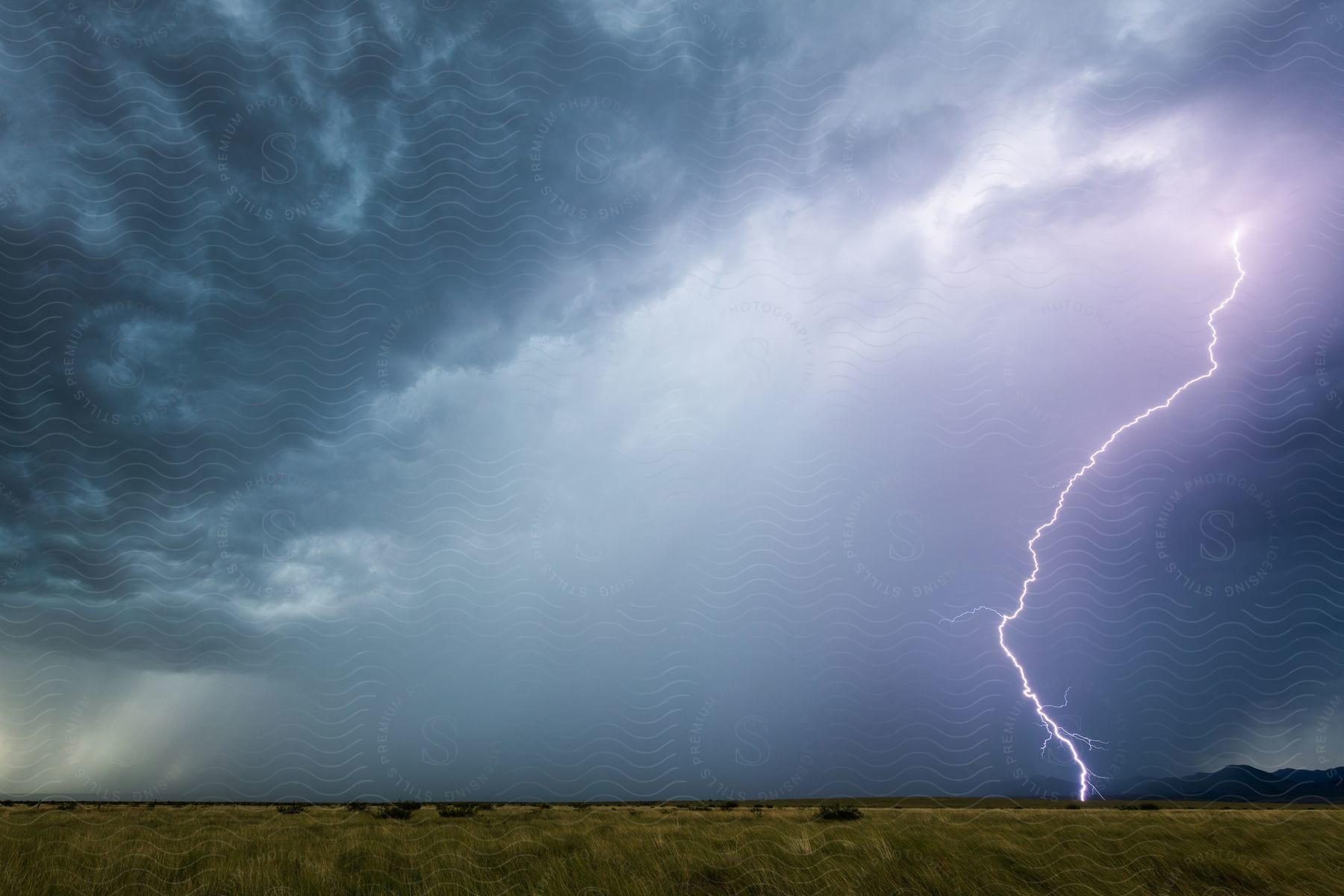 Lightning And Rain Falling From Storm Clouds In The Plains