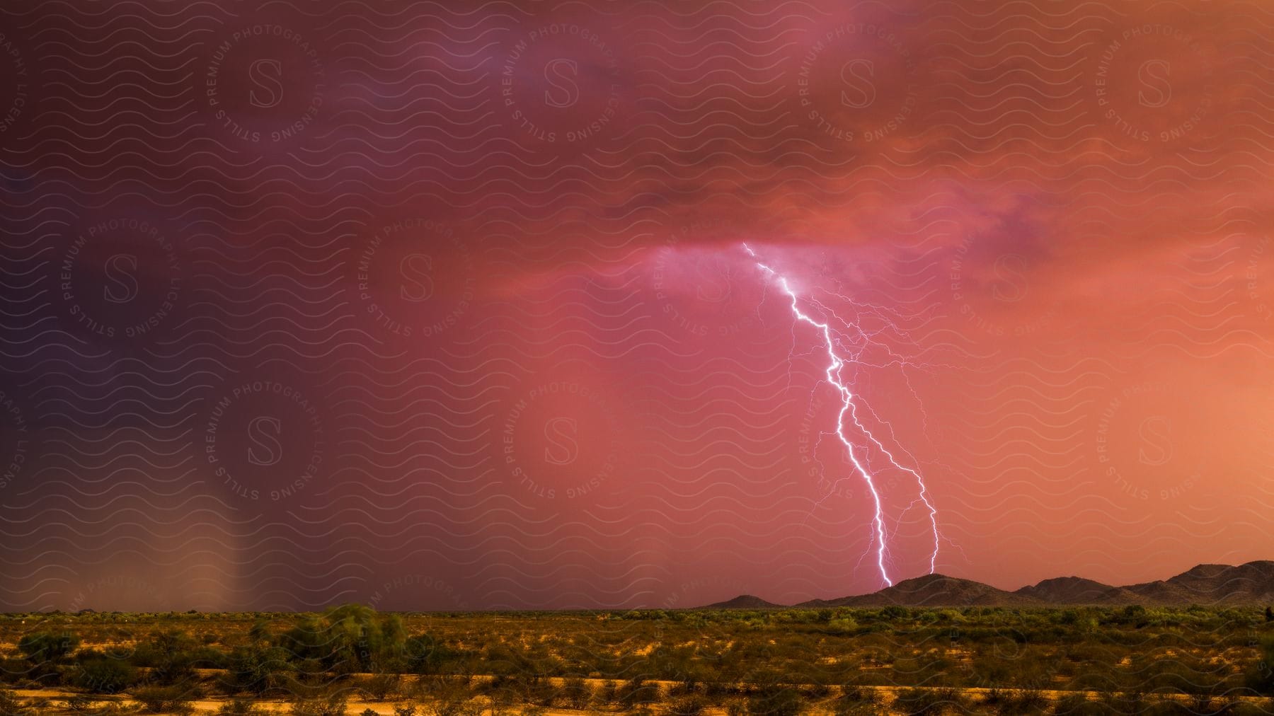 A colorful lightning show at dusk during a thunderstorm