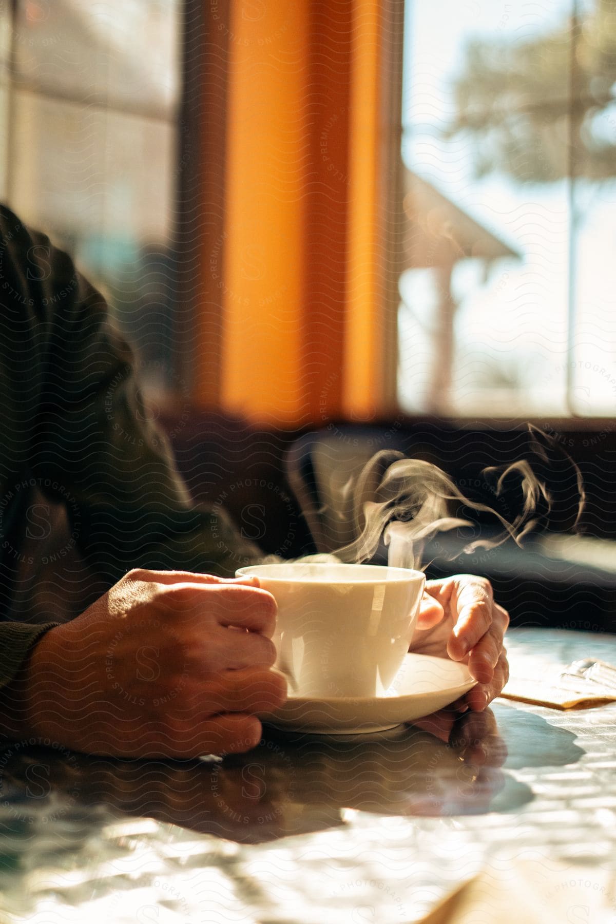 A person about to drink coffee at a table