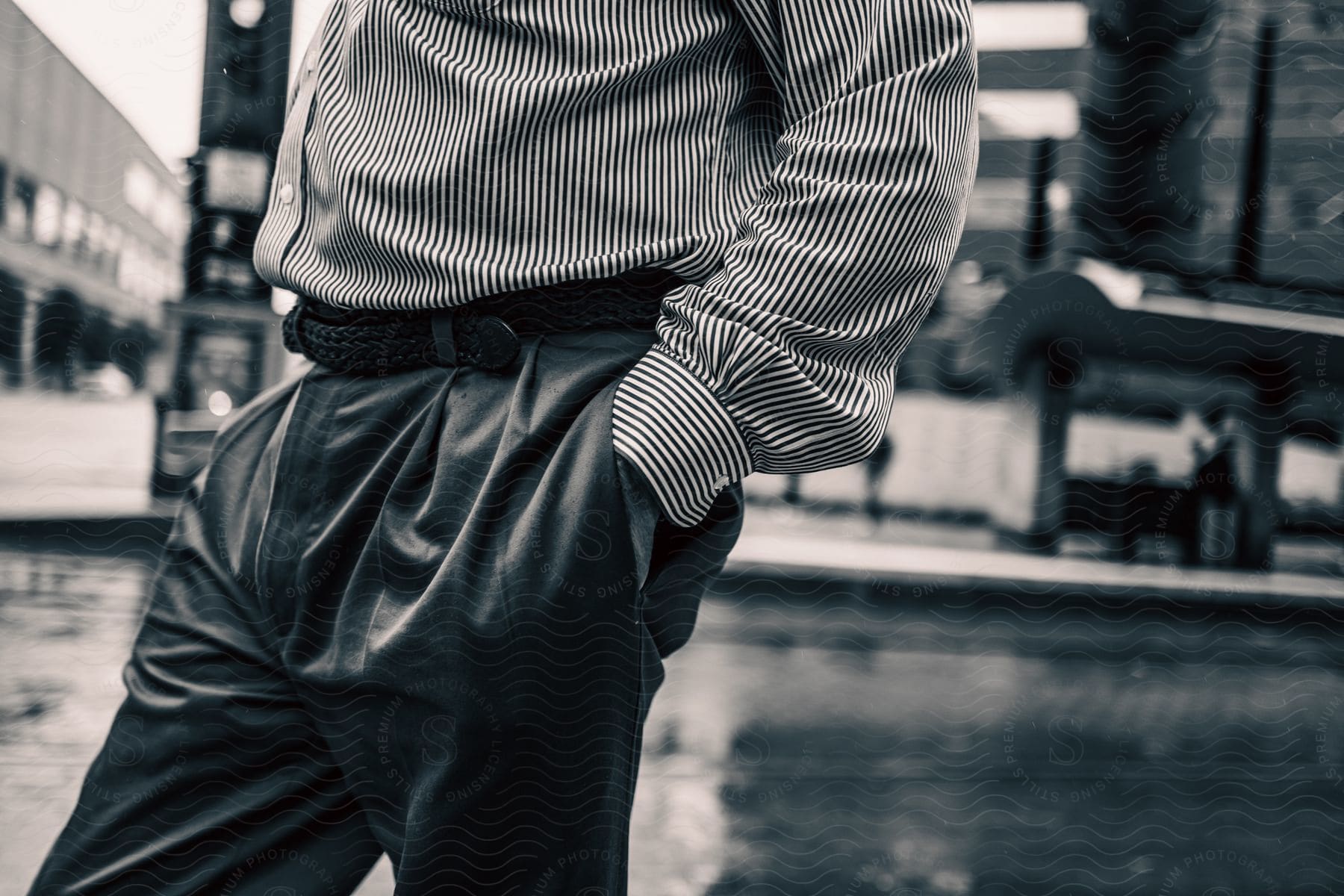 A man wearing a coat and dress shirt standing with a neutral expression