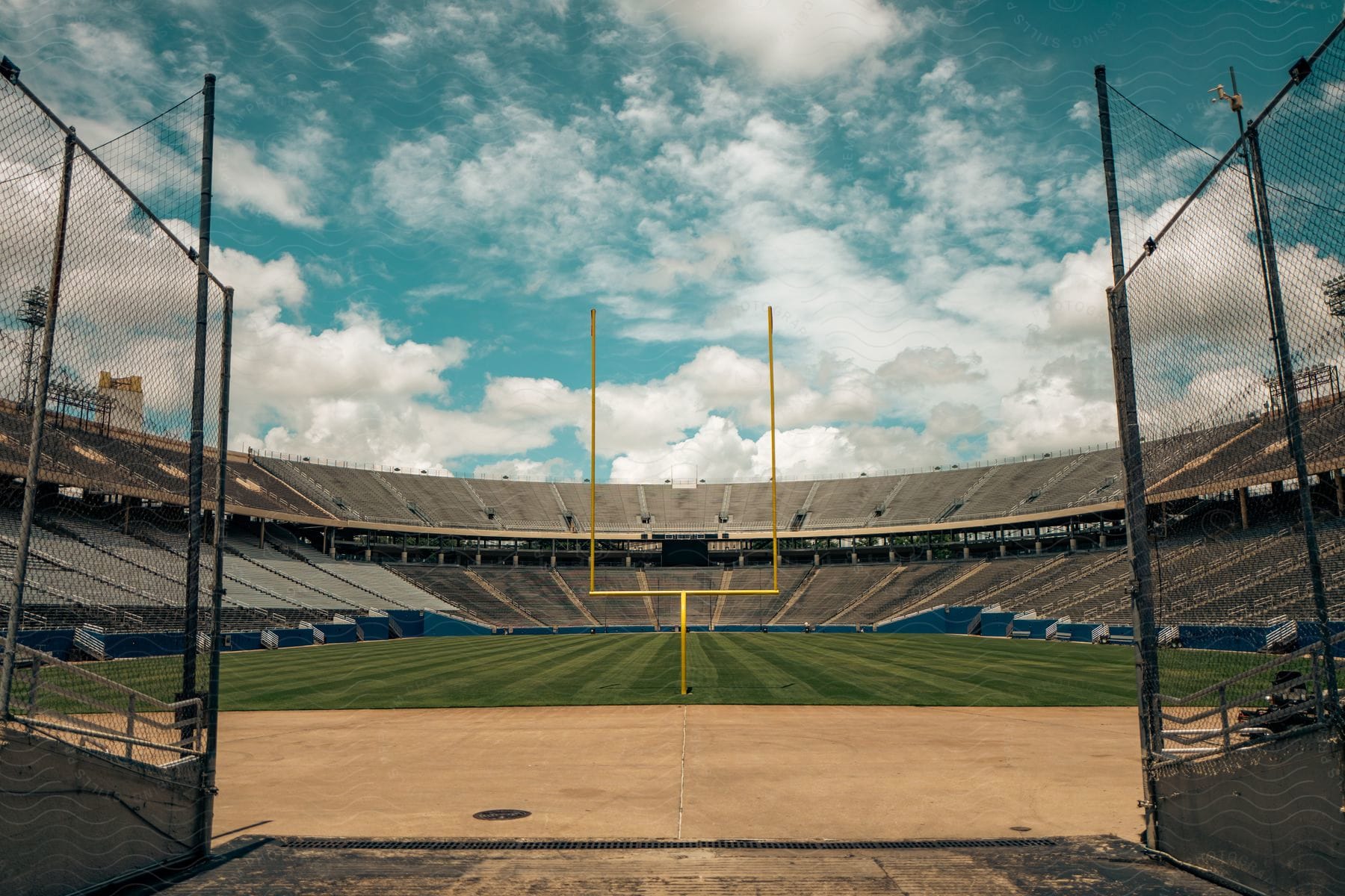 A football field in a stadium during the day