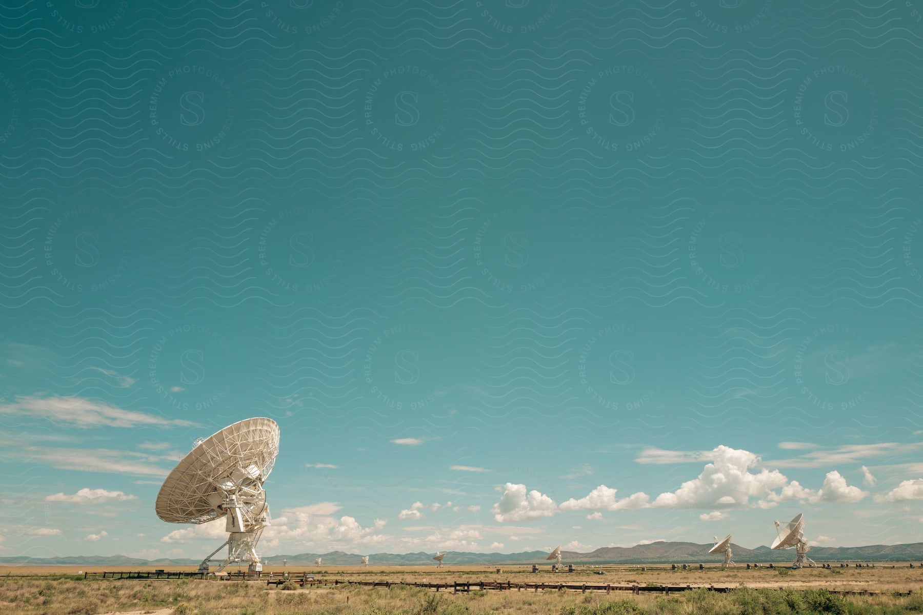 A natural landscape with a parabolic antenna in the sky