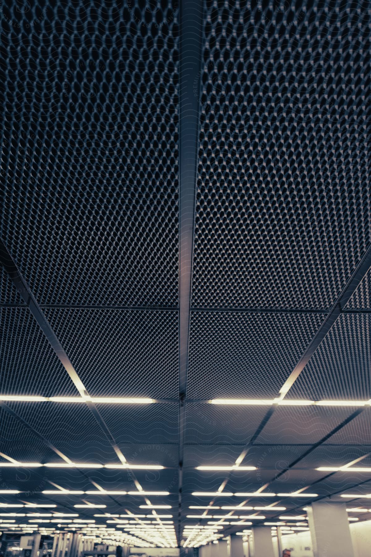 Ceiling tiles and lights arranged in square patterns in an indoor space