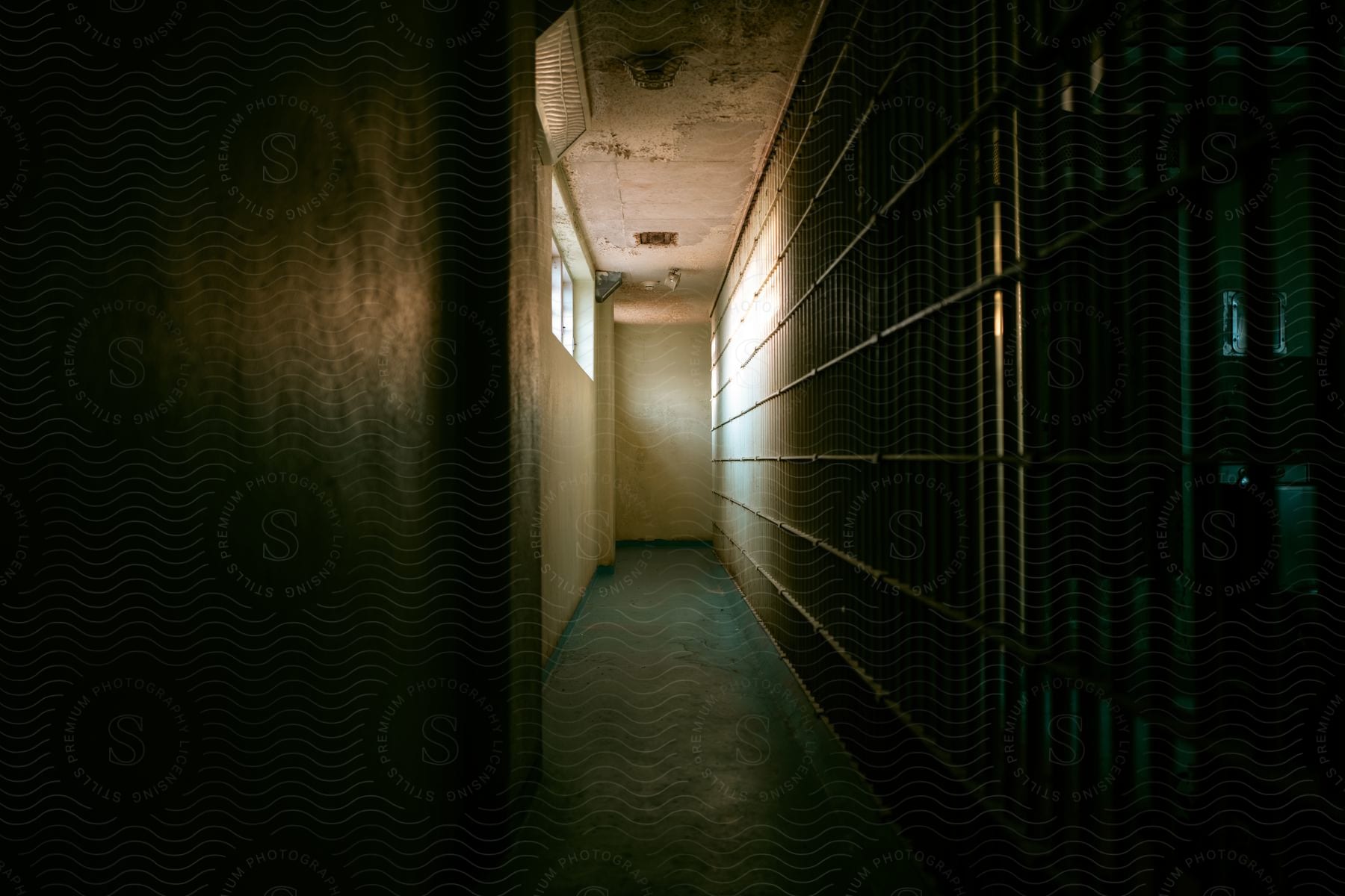 Jailhouse hallway corridor with cell block bars on one side